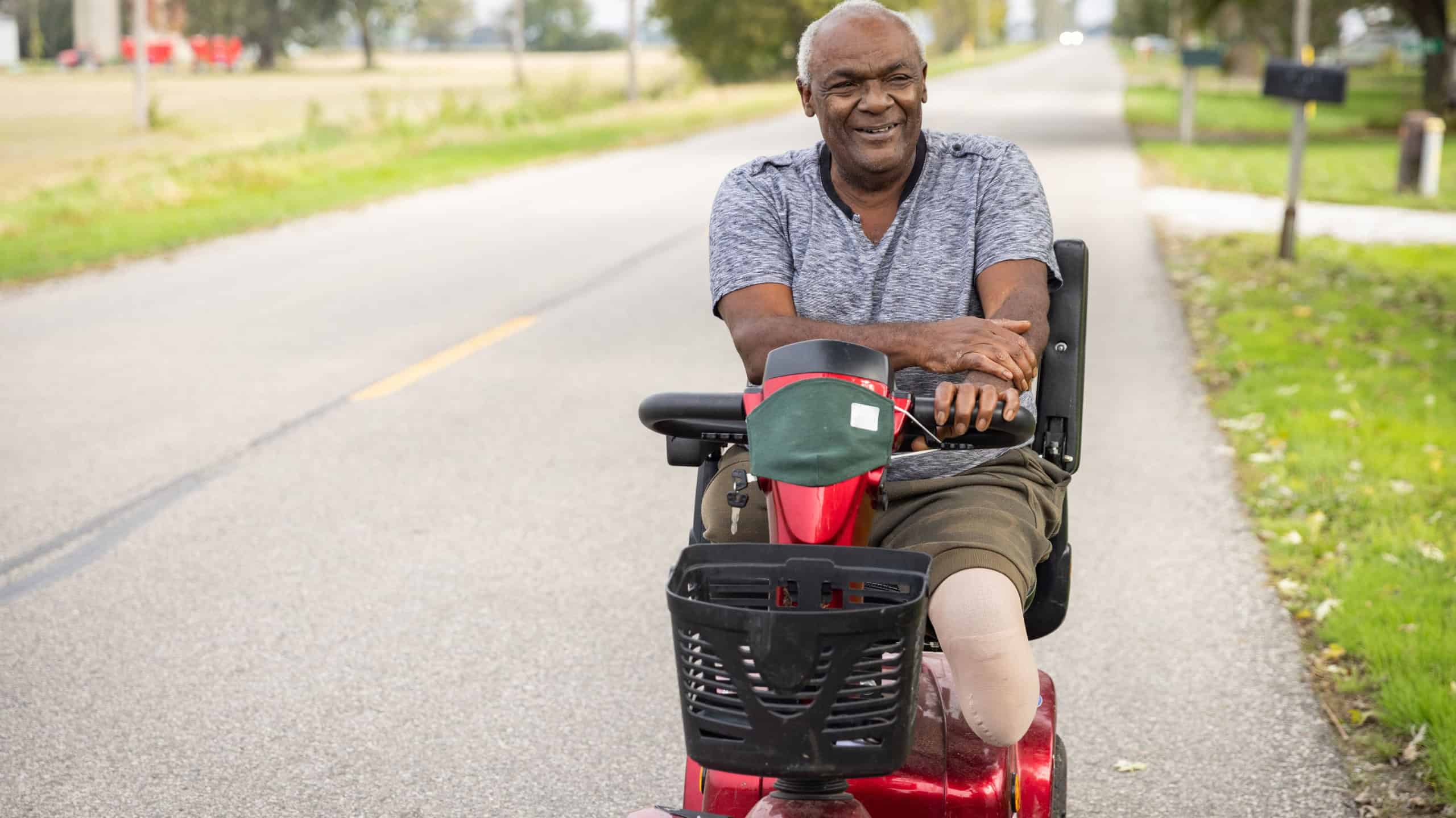 Senior happy man driving an electric mobility scooter