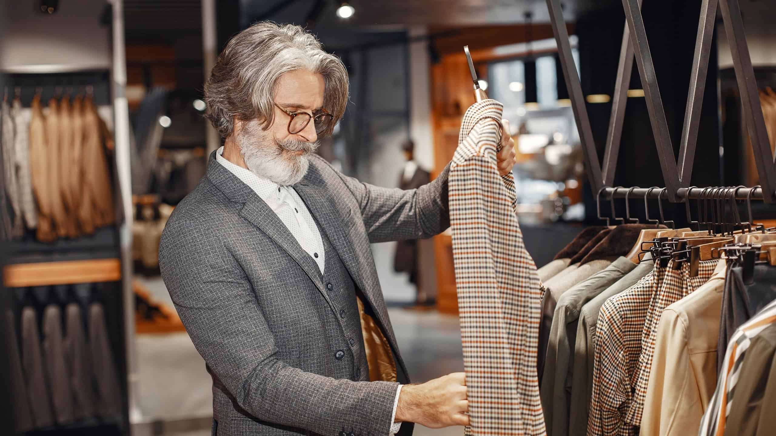 Senior man choosing a new suit in a store