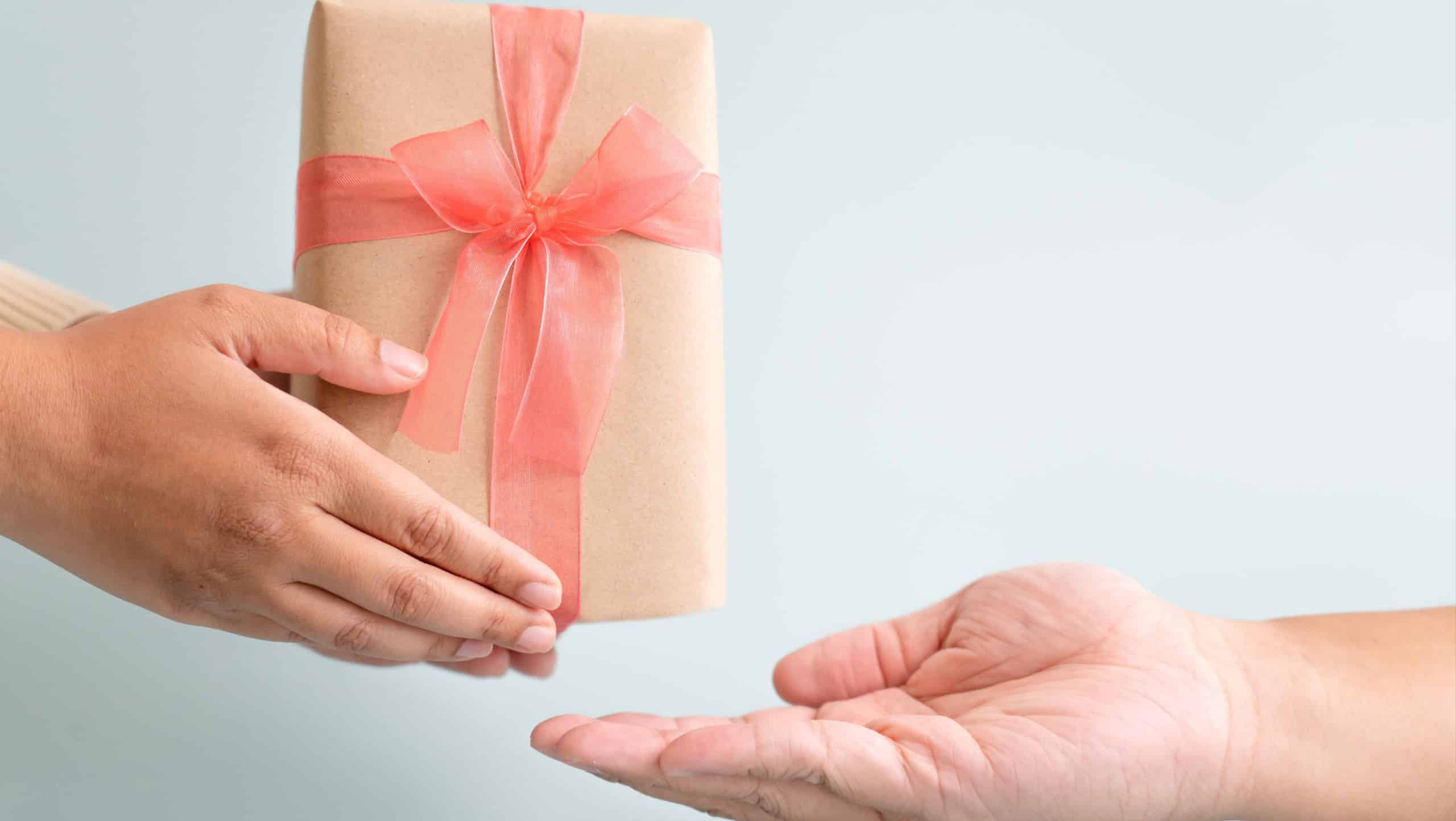 Sending and receiving gift with ribbon bow for special occation to someone you love. Holidays seasonal to give and to take gift box surprised.