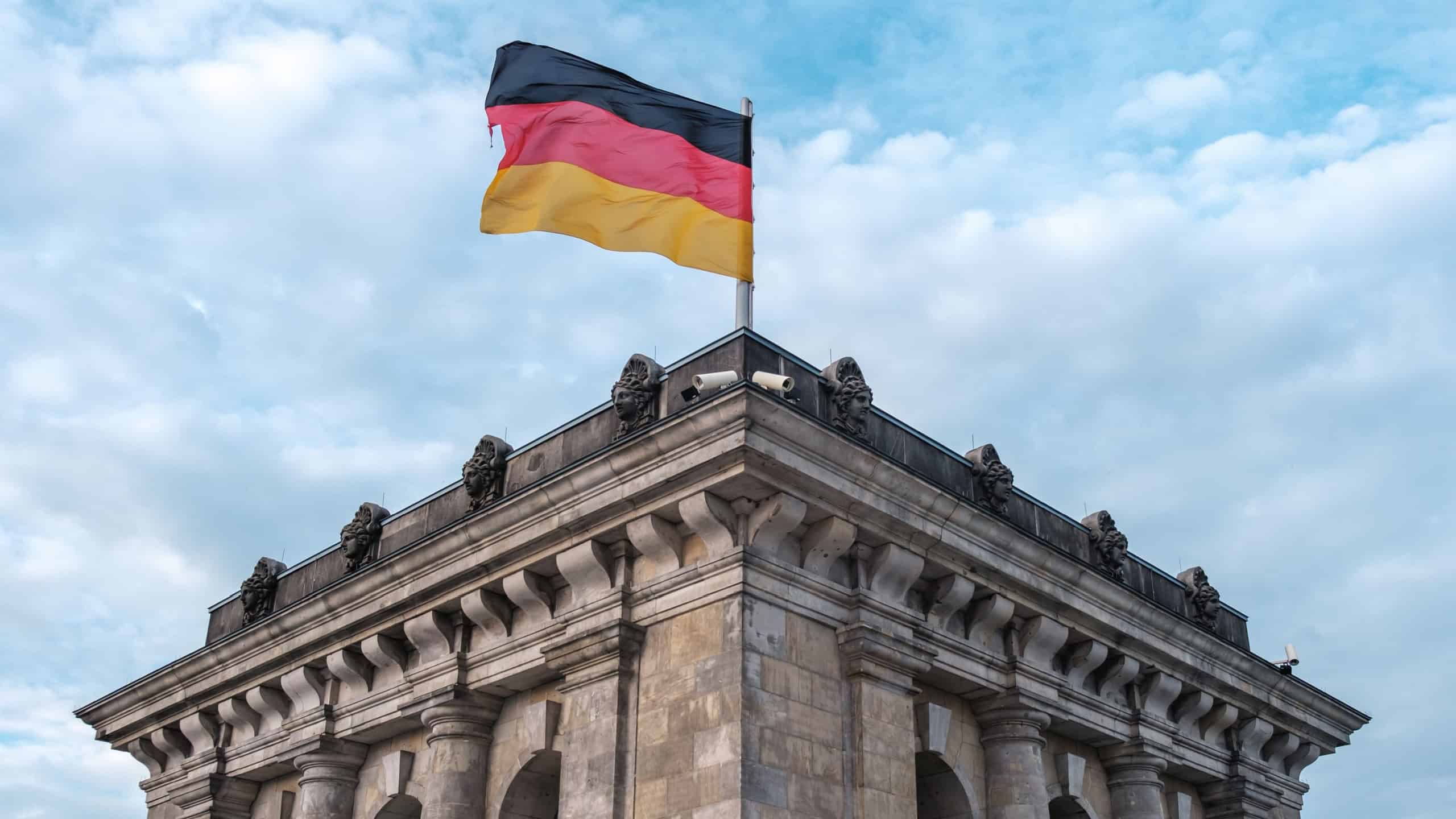 The German Flag Flying Atop The Reichstag In Berlin, Germany