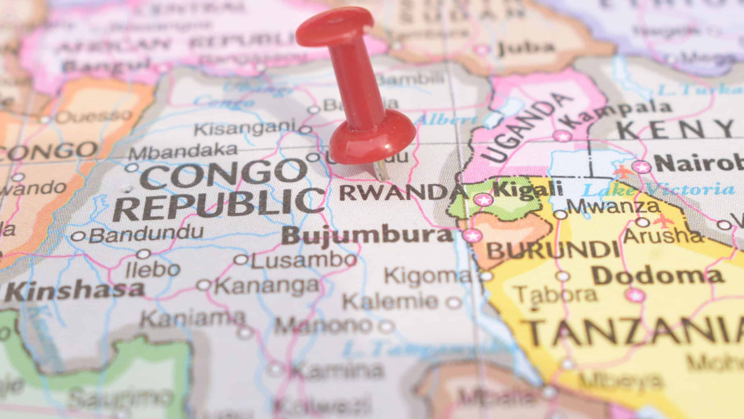 Red Push Pin Pointing on Rwanda Country Name On The Political World Map Close-Up View Stock Photograph