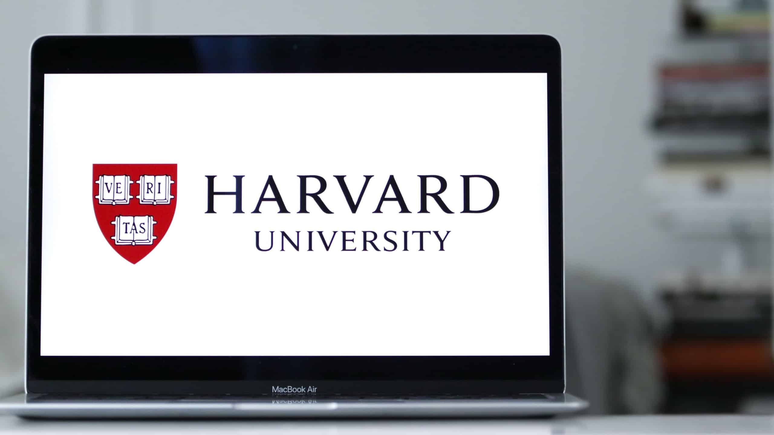 NEW YORK, US - Sep 13, 2022: A MacBook Air rests on a desk, its screen displaying the Harvard University logo