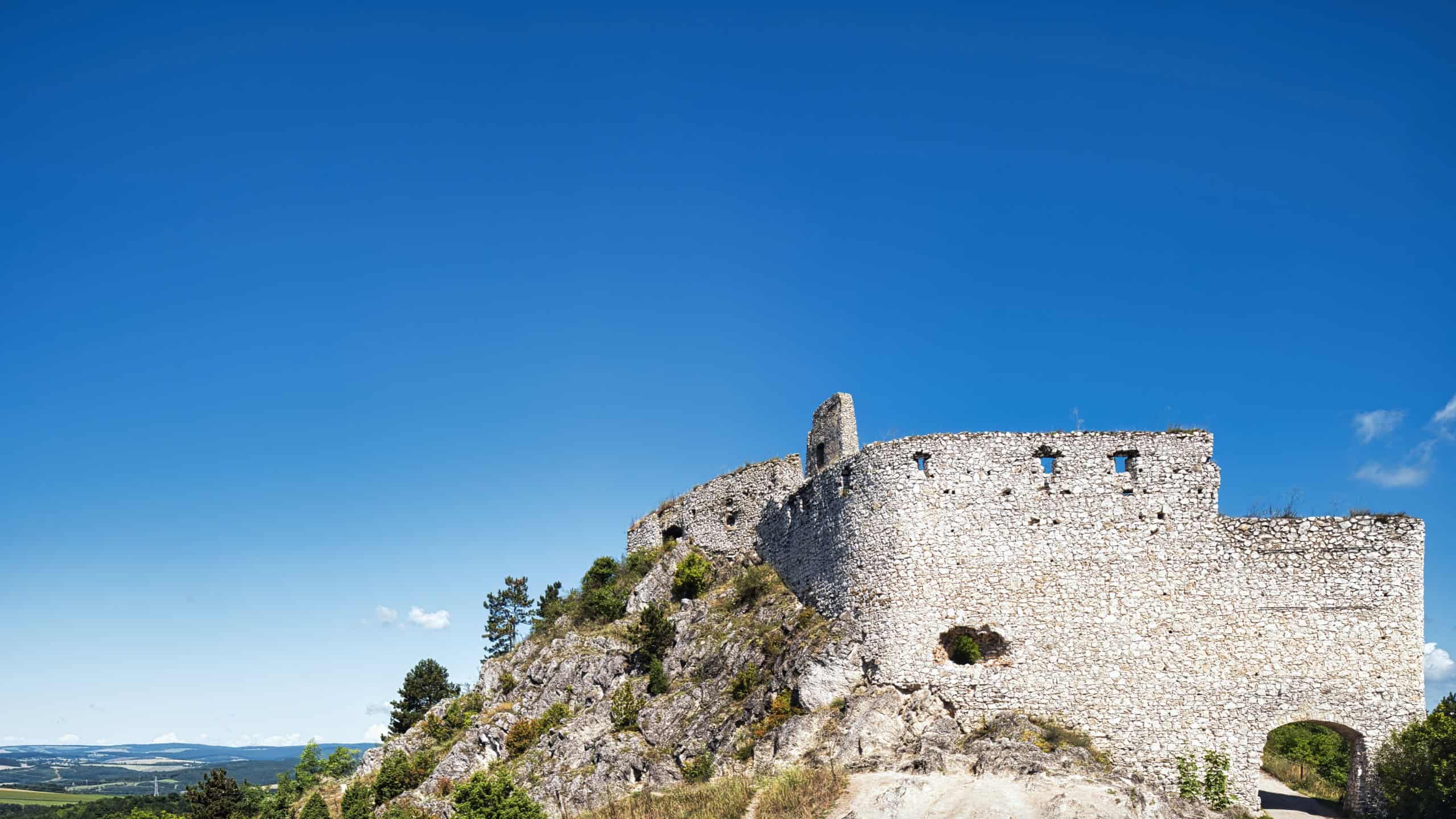 Cachtice Castle ruins in Slovakia, medieval hilltop fortress linked to Elizabeth Bathory, with stone walls and blue sky