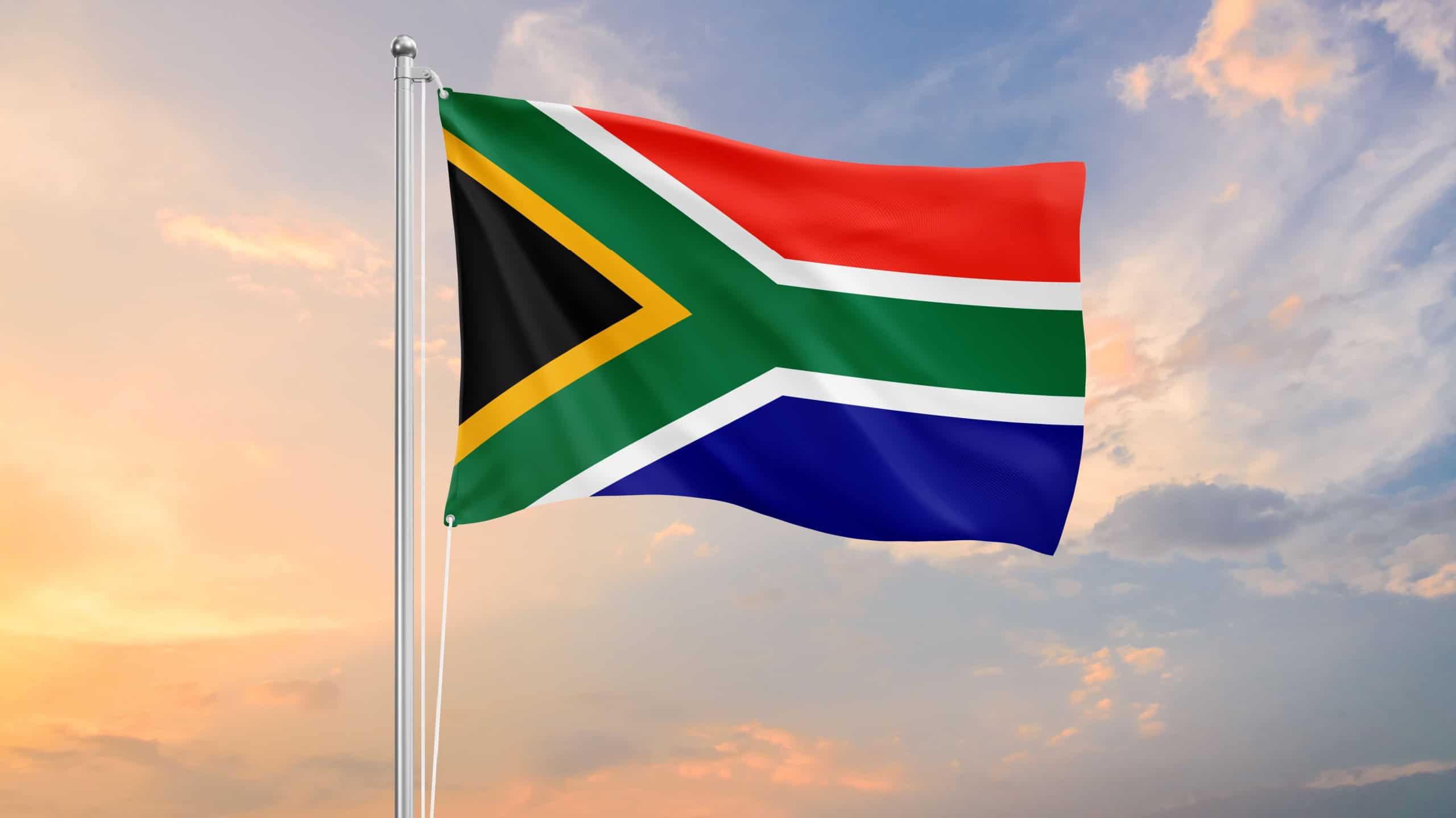 South Africa flag waving on sundown sky