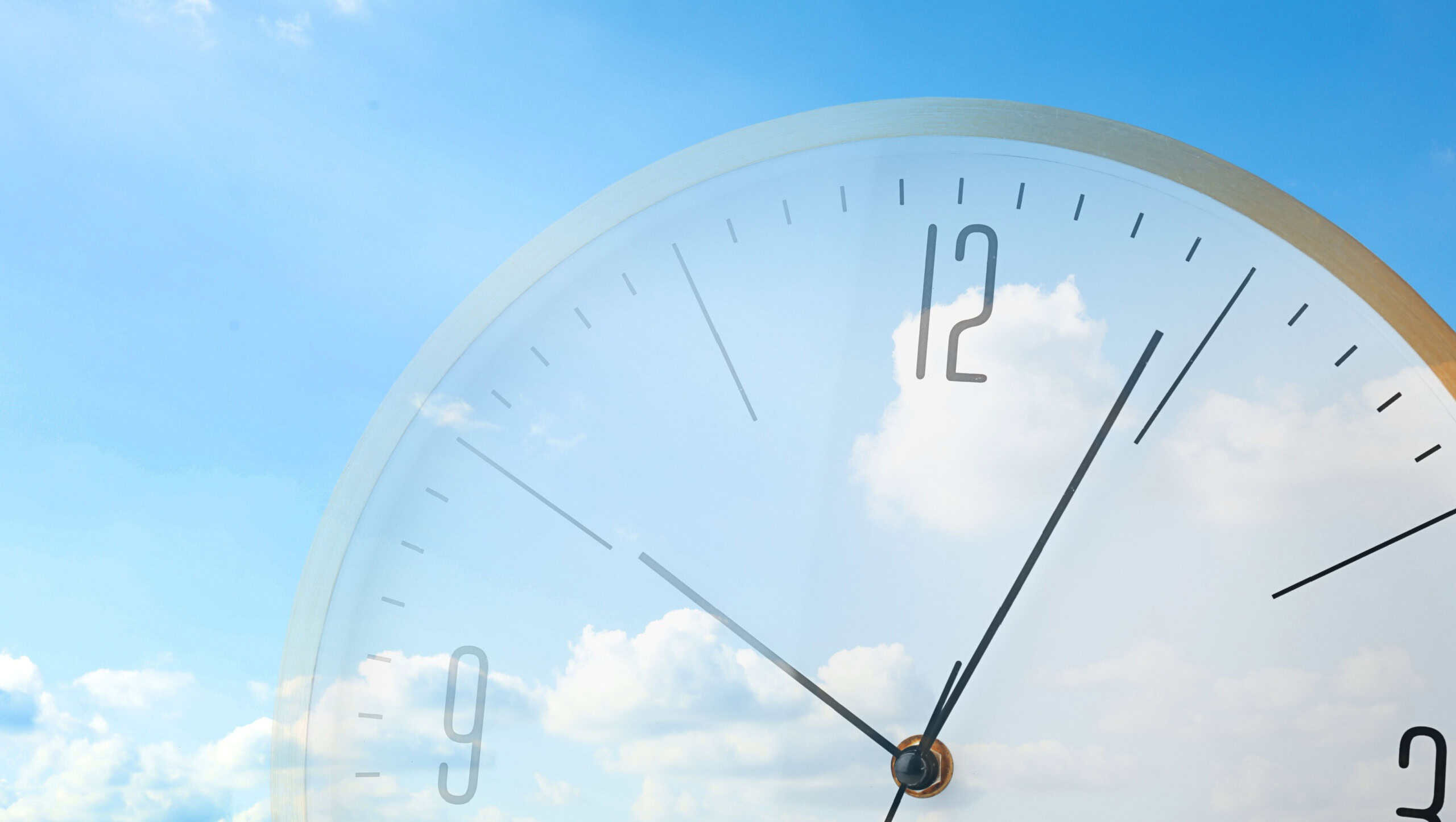 Time concept. Double exposure of blue sky with fluffy clouds and clock