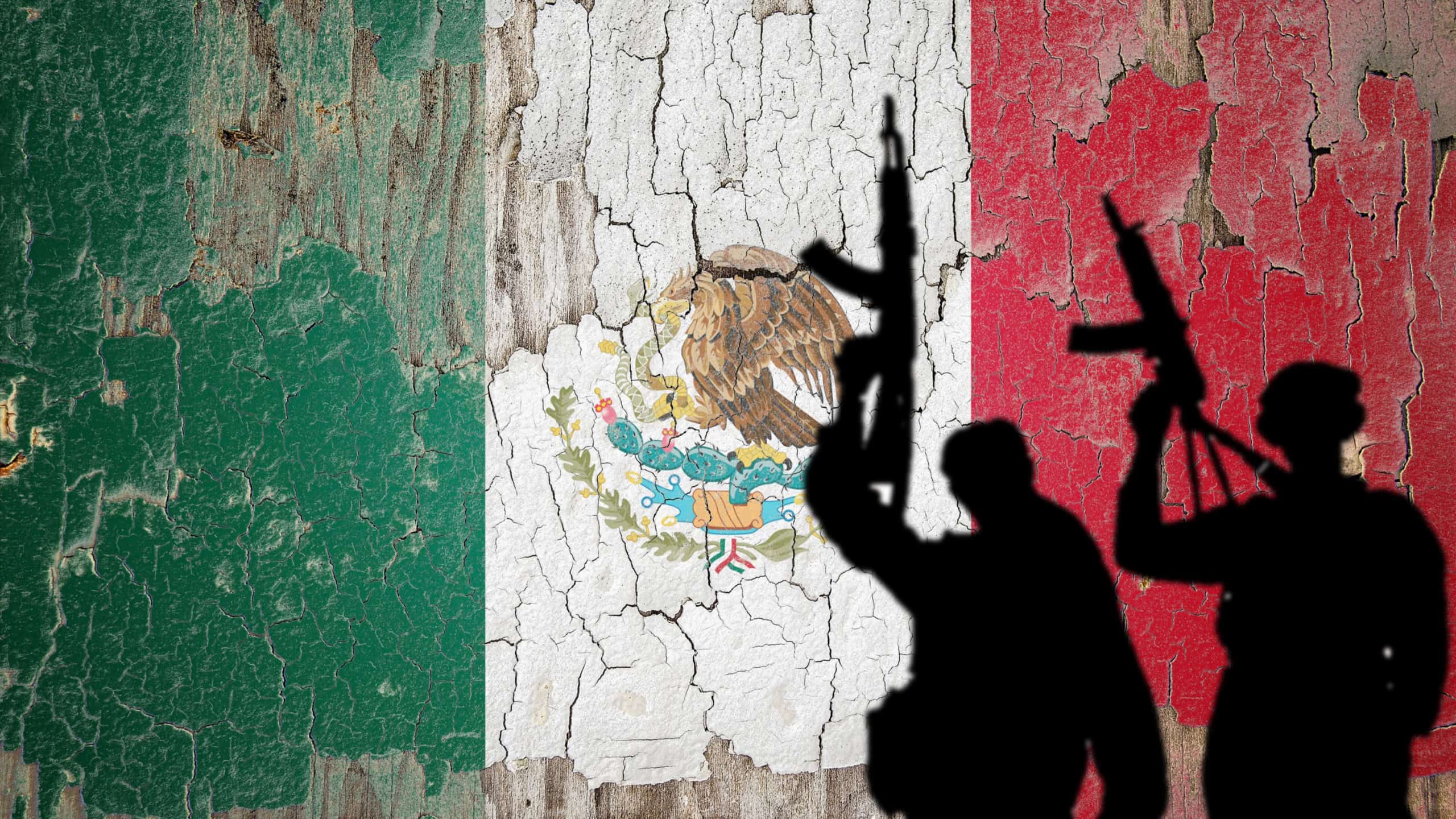 Flag of Mexico painted on the cracked wall with terrorist shadow.