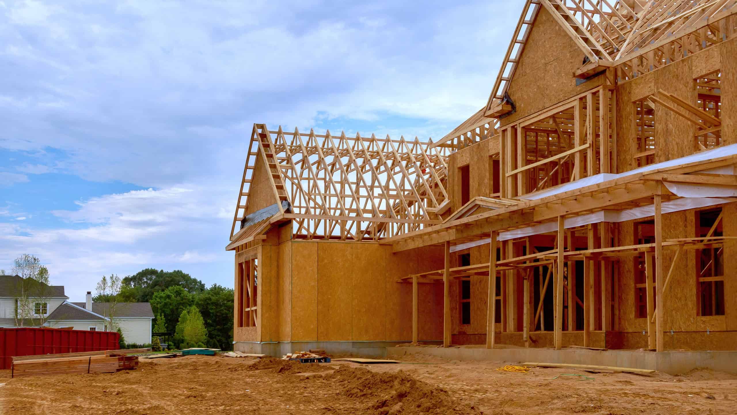 Newly constructed house with unfinished interior with wooden stud timber framing supports beams