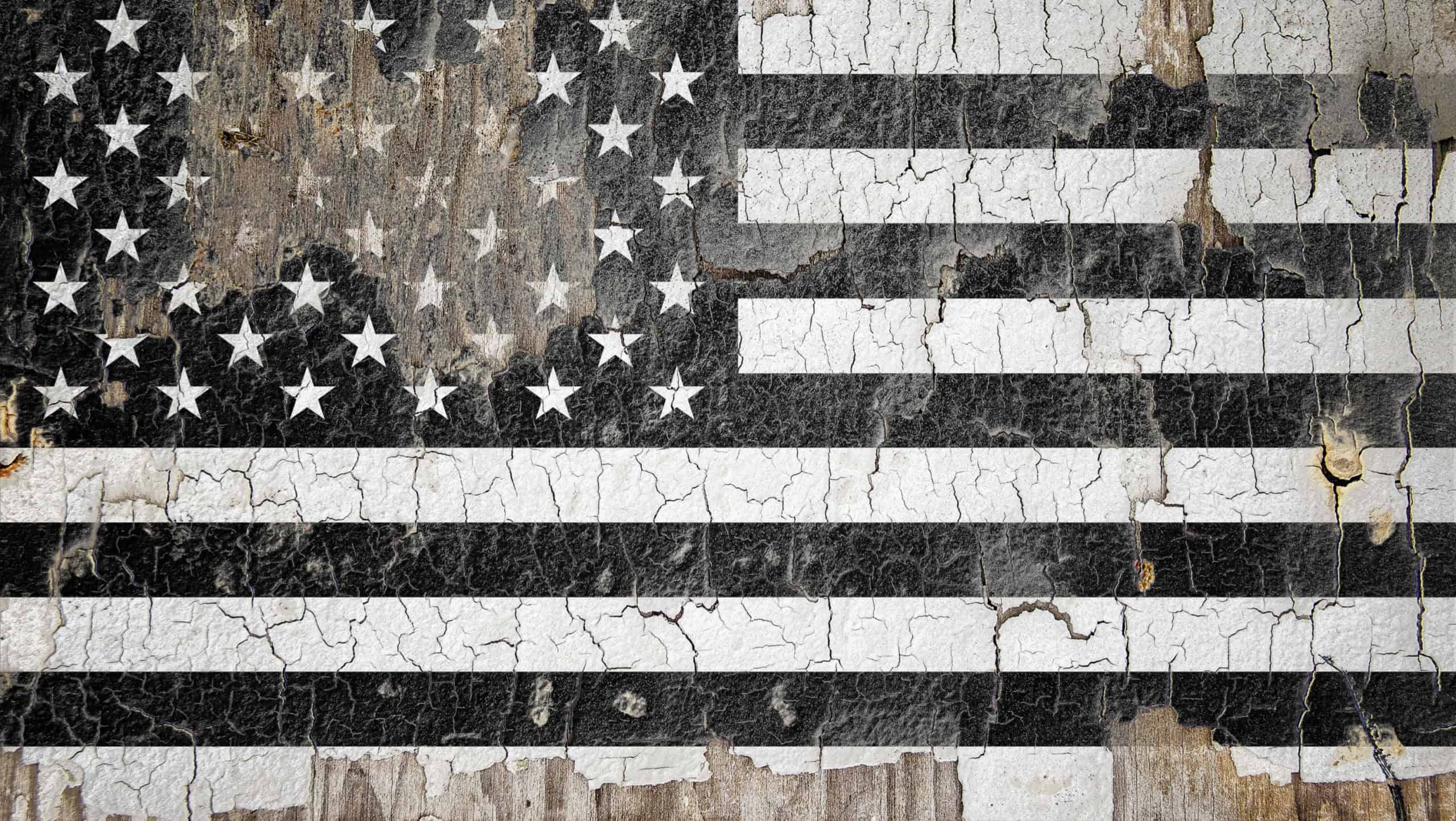 Memorial USA flag. A black and white USA flag painted on the cracked wall