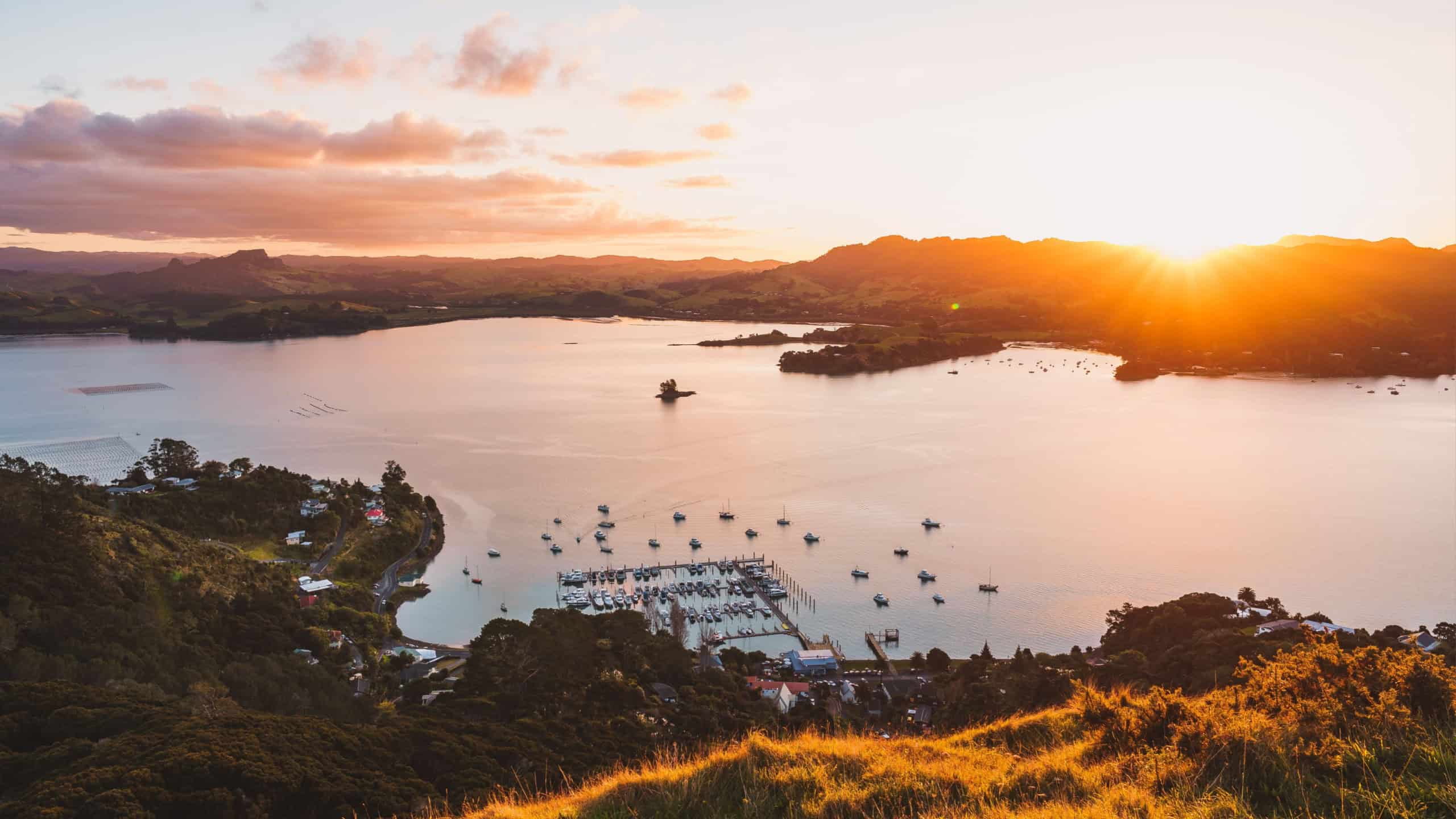 An aerial drone shot of St Paul's Rock (Ohakiri) at sunset in Whangaroa, New Zealand