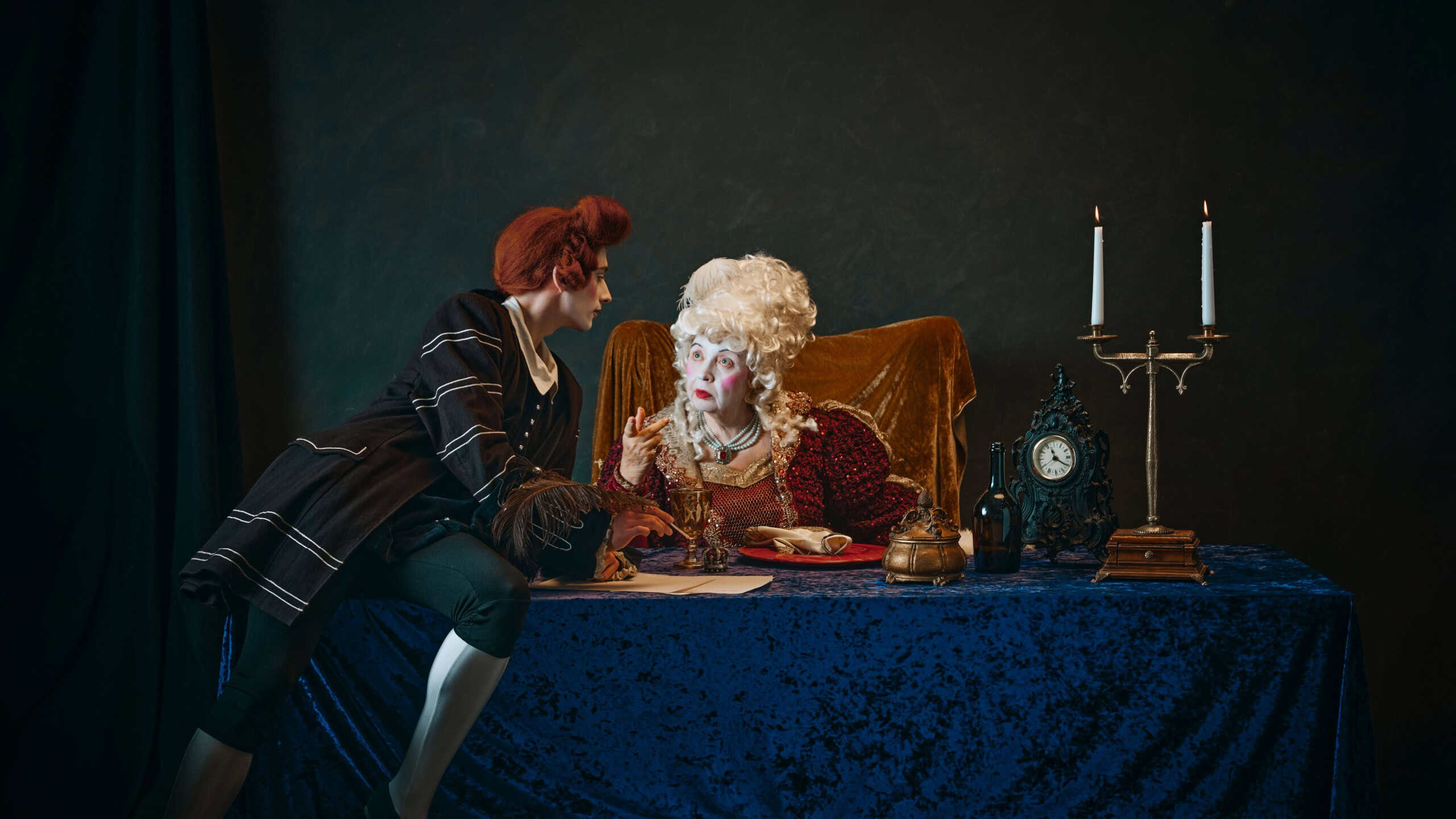 Elderly noble empress and her favorite court member sharing secrets at dinner table. Woman dressed in traditional 18th-century gown, young man wearing redhead wig. History, comparison of eras concept