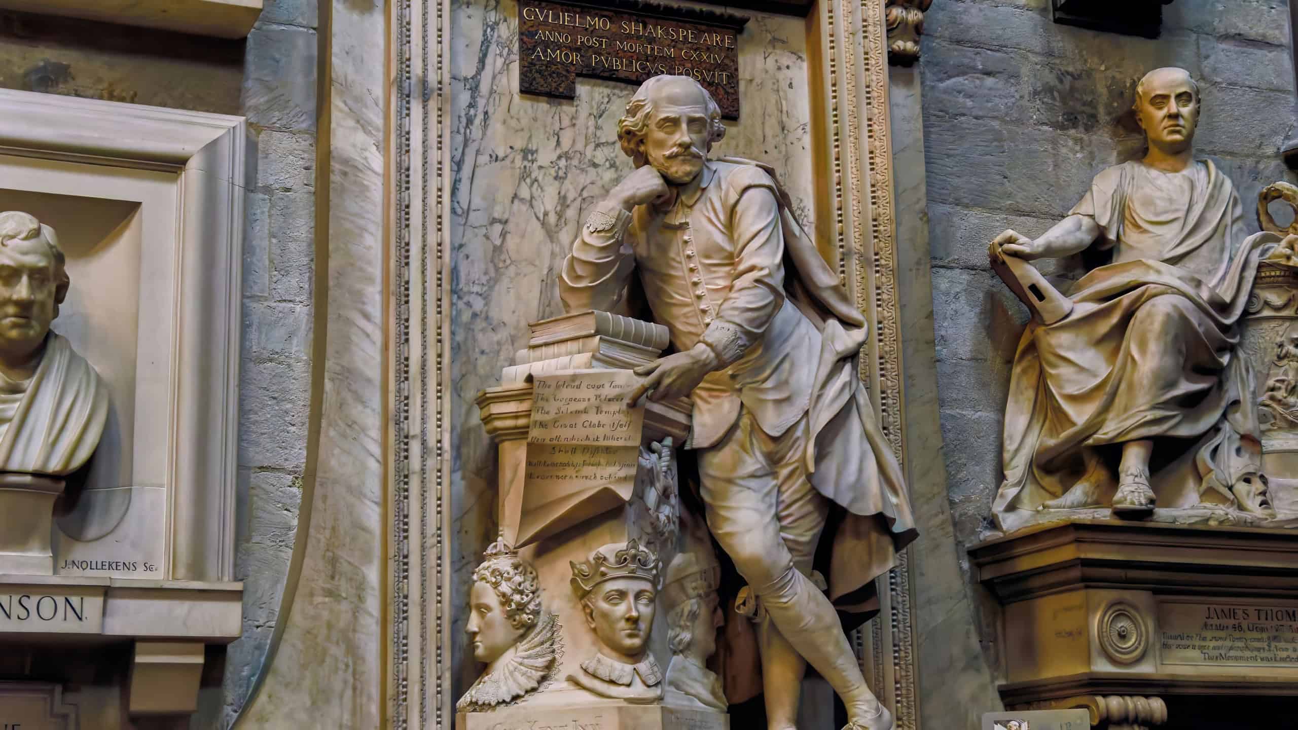 White marble statue of Shakespeare in Renaissance costume with books in Westminster Abbey, London