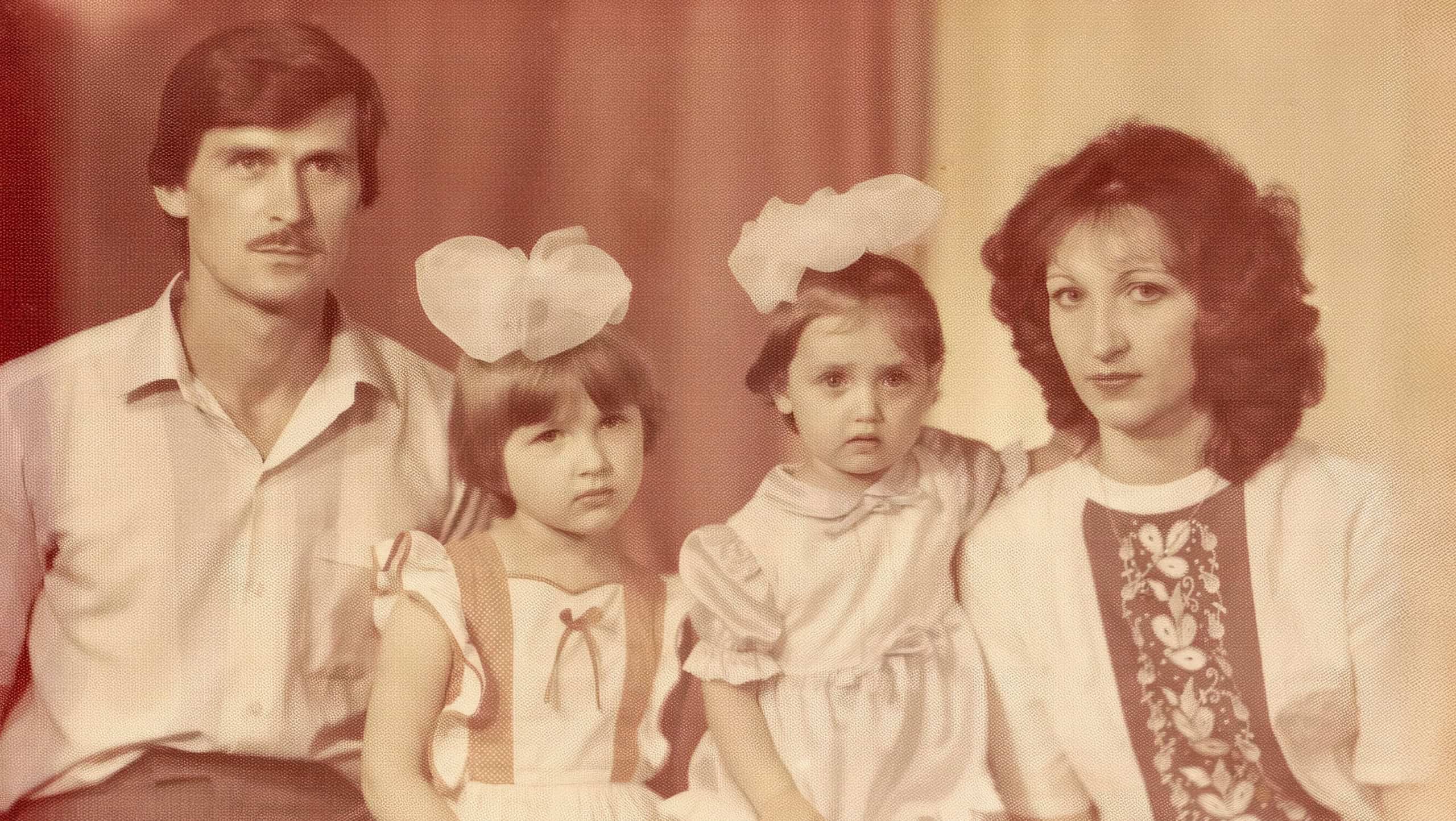 USSR, MOSCOW- CIRCA 1988: Vintage color soviet family photo in studio. The girls have a bow on their heads.