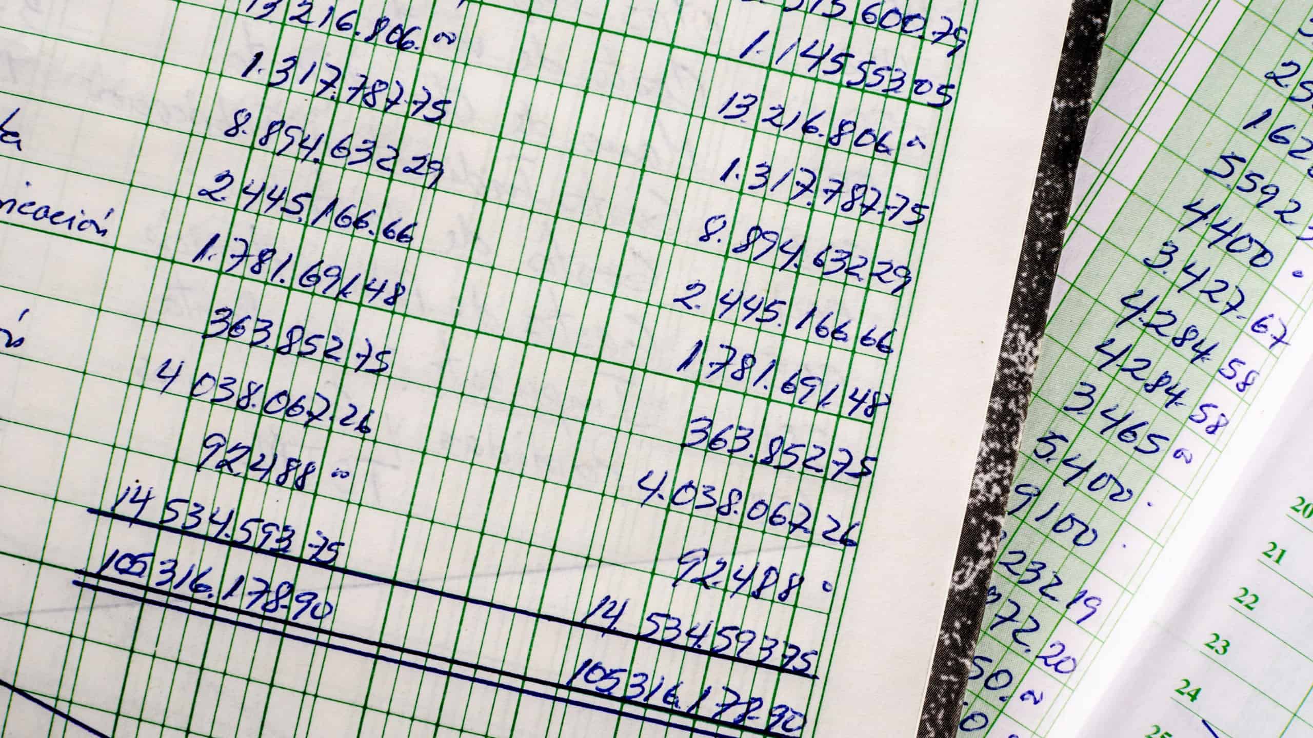 Handwritten accounting on the open pages of some old ledgers