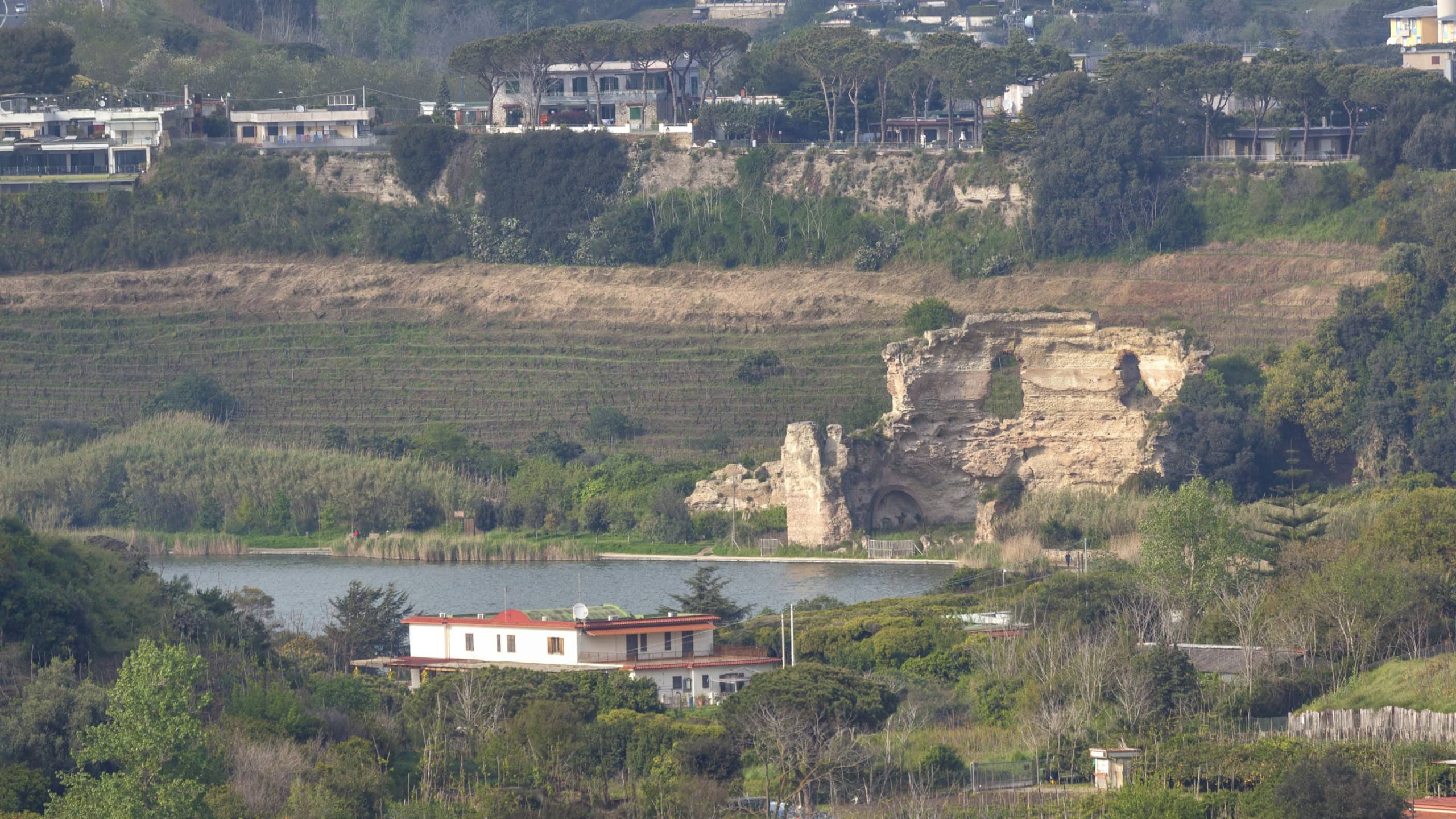Lake Avernus (lago d'Averno) with great roman ruins called temple of Apollo at Phlegrean fields near Pozzuoli, Italy