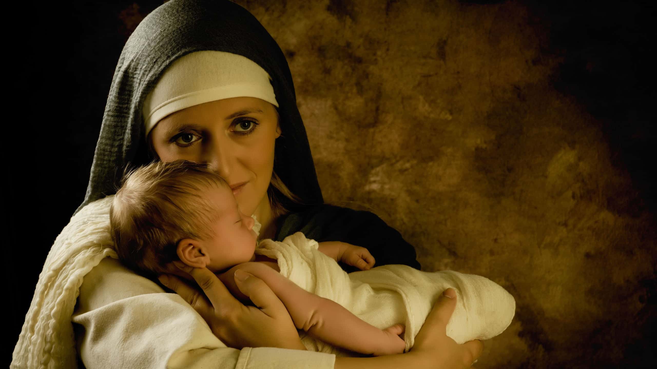 Live reenactment Christmas nativity scene of the real mother of an 8 days old baby boy playing Virgin Mary and baby Jesus