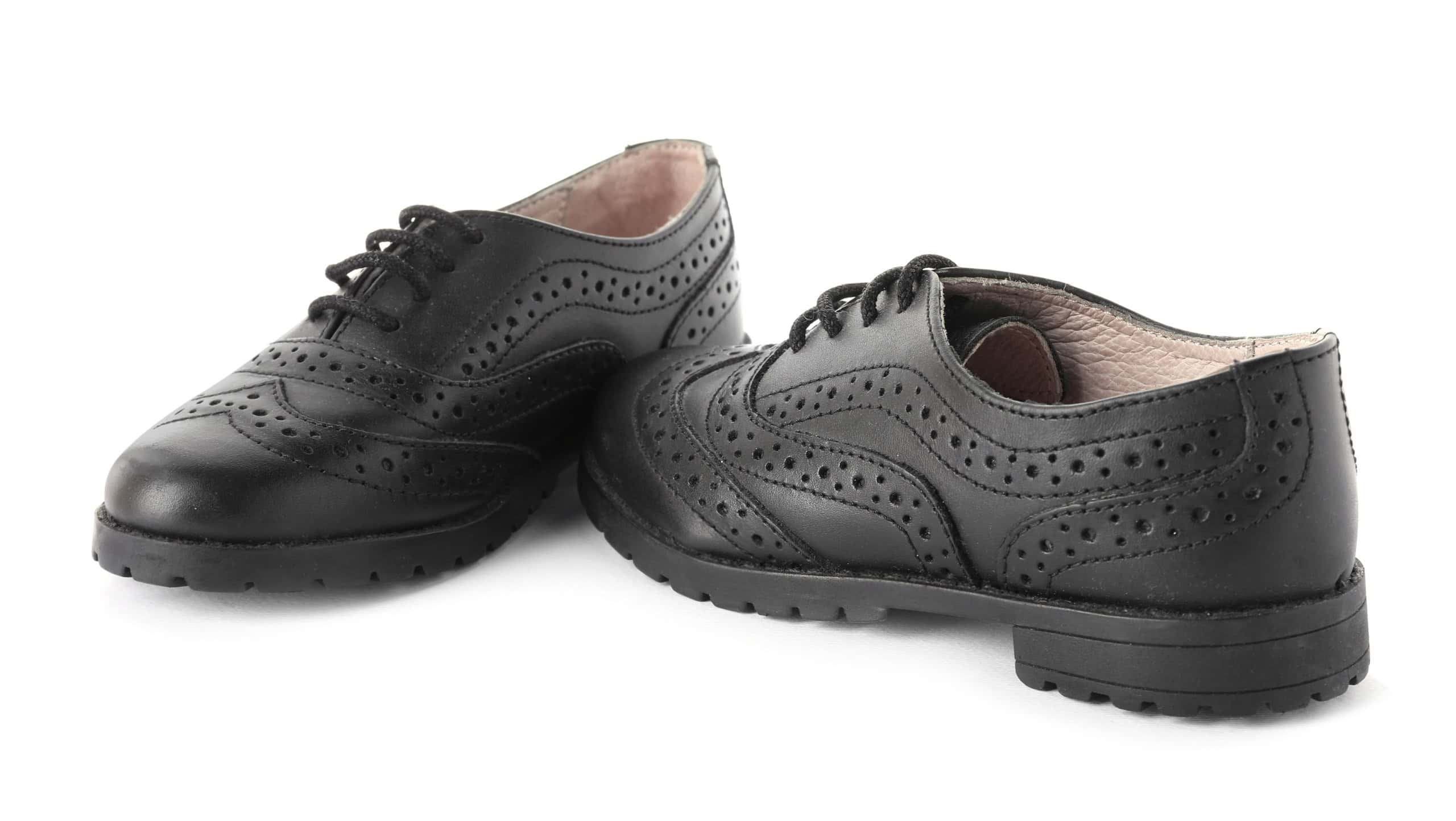 Pair of stylish kid's brogue shoes isolated on white