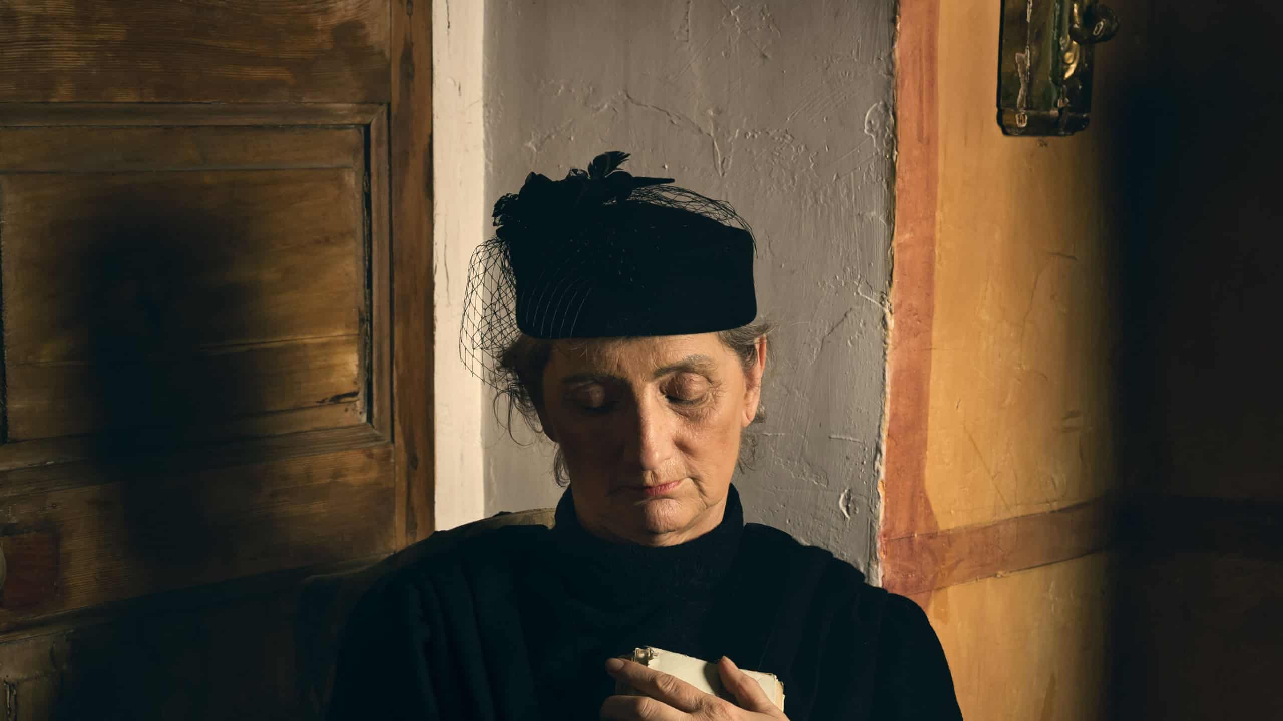 Portrait of a widow dressed in authentic Victorian dress and matching hat