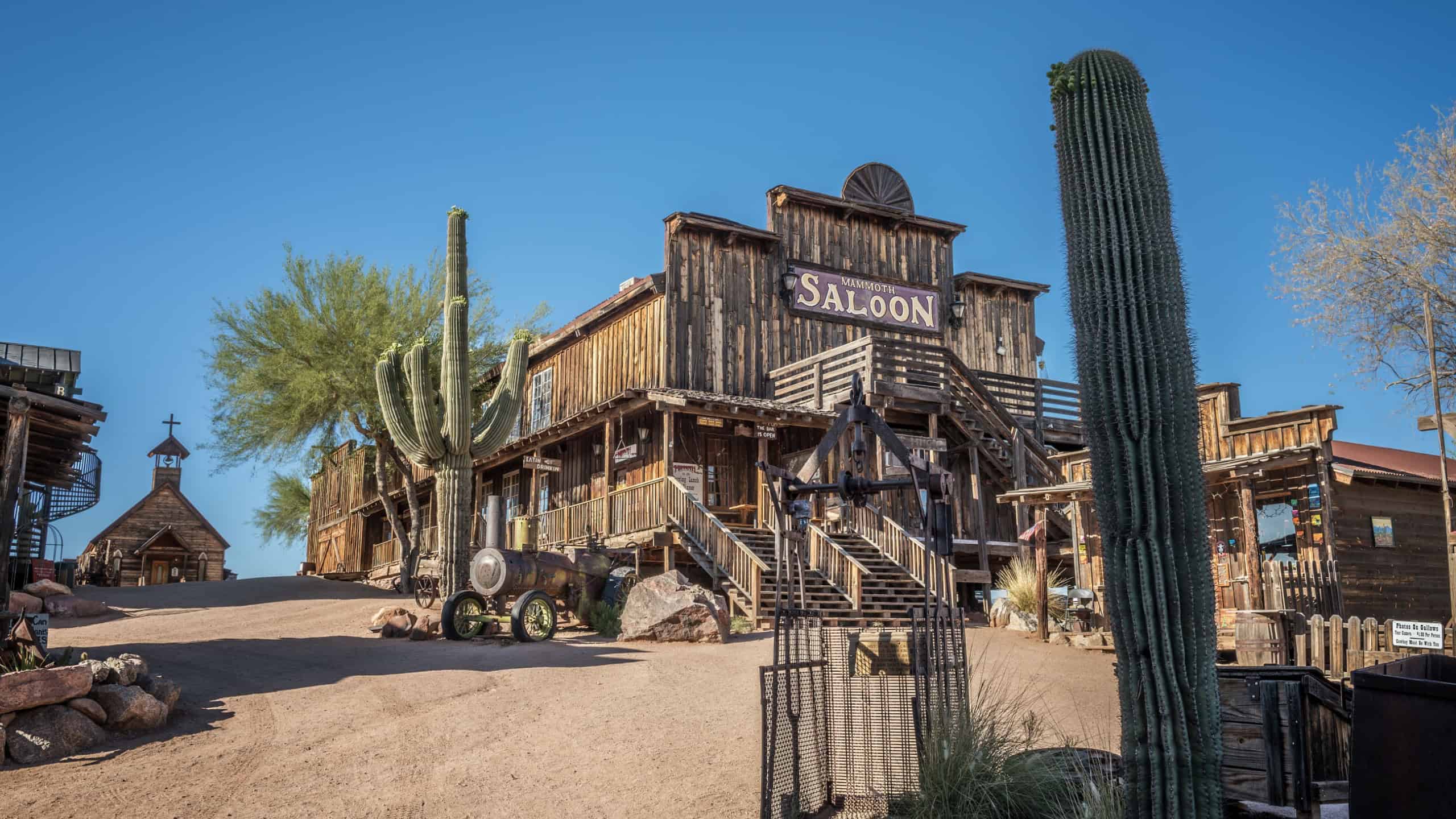 GOLDFIELD, ARIZONA, USA - MAY 17, 2016 : Old saloon and wooden church in Goldfield Ghost town. Goldfield, later Youngsberg was a gold mining town, now a ghost town in Pinal County, Arizona.