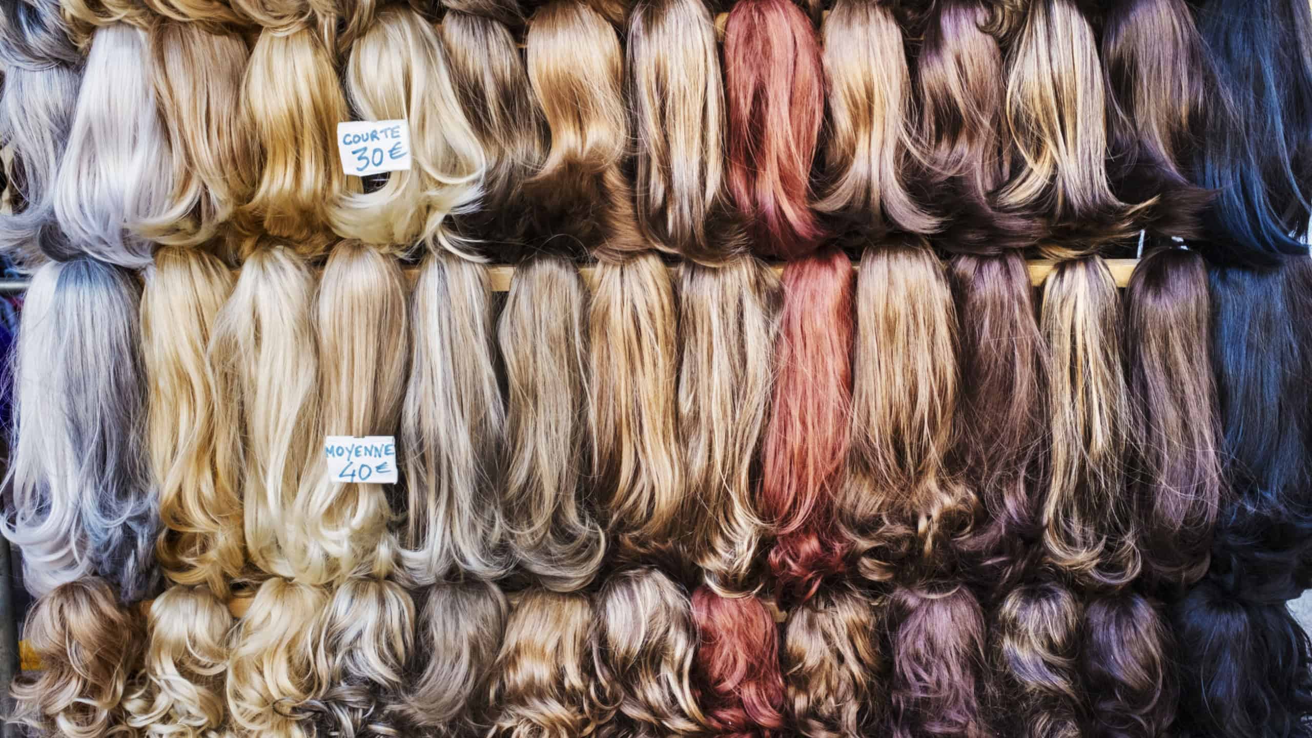 A display of hair extensions and hair pieces of different colours,