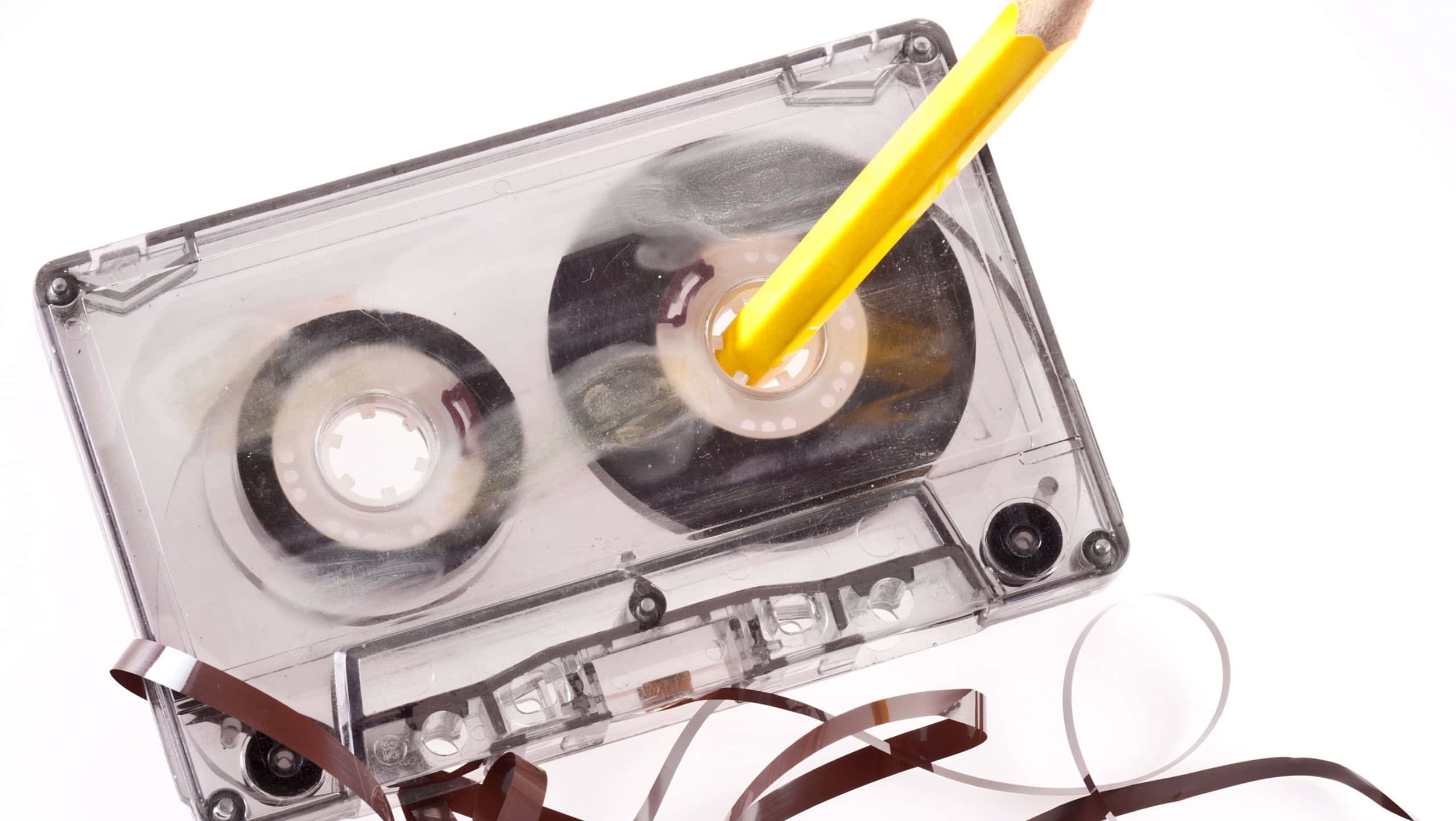 Old broken cassette isolated on white