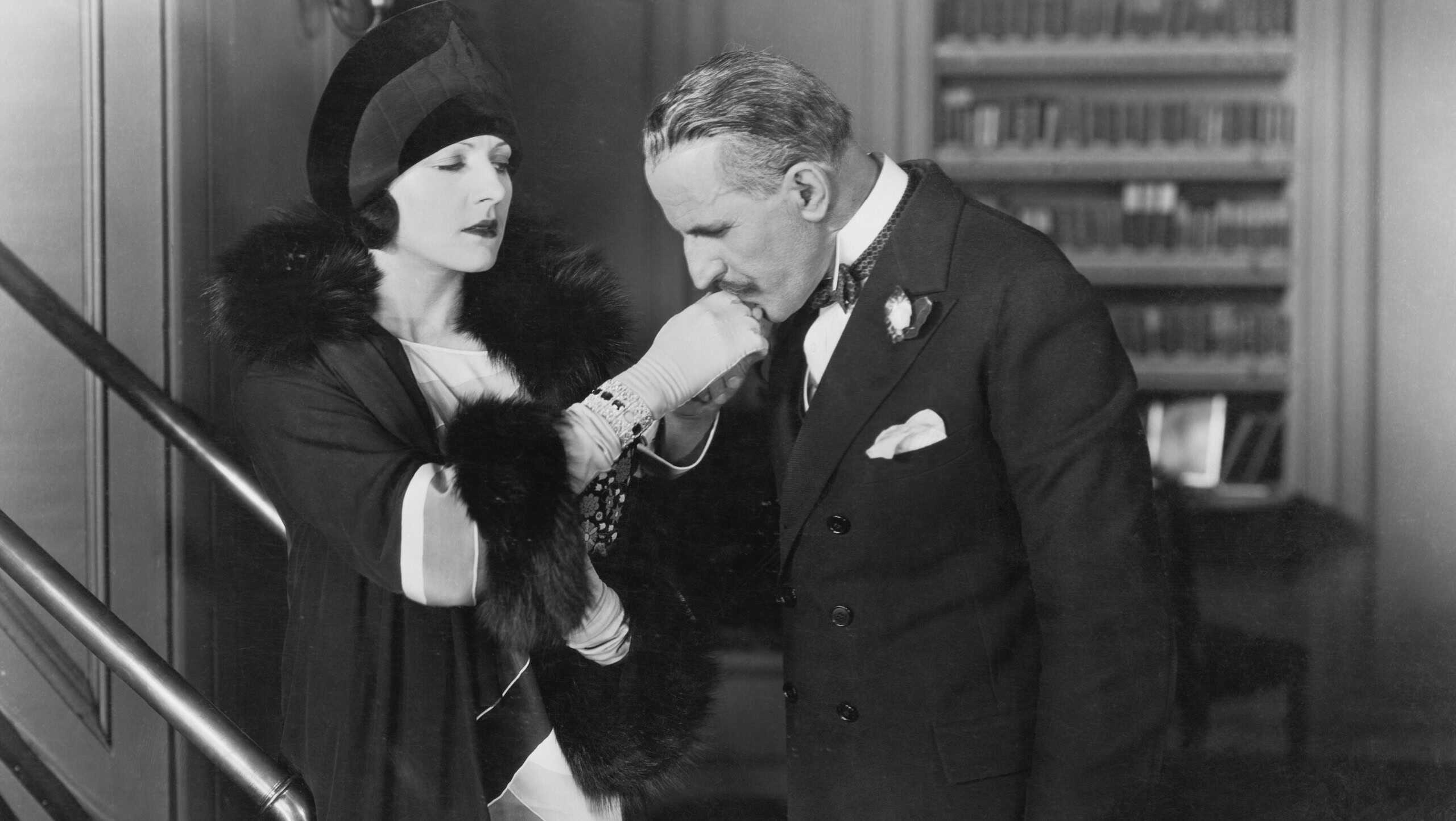 Man kissing womans hand