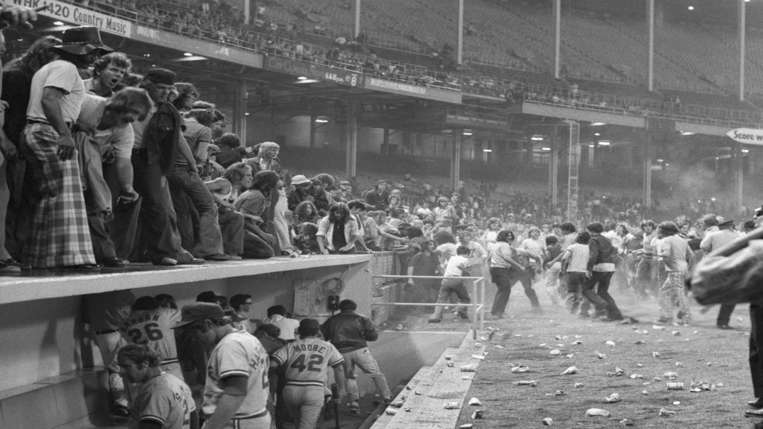 Texas Rangers run toward the dressing room as fans invade the field during the Ten Cent Beer Night