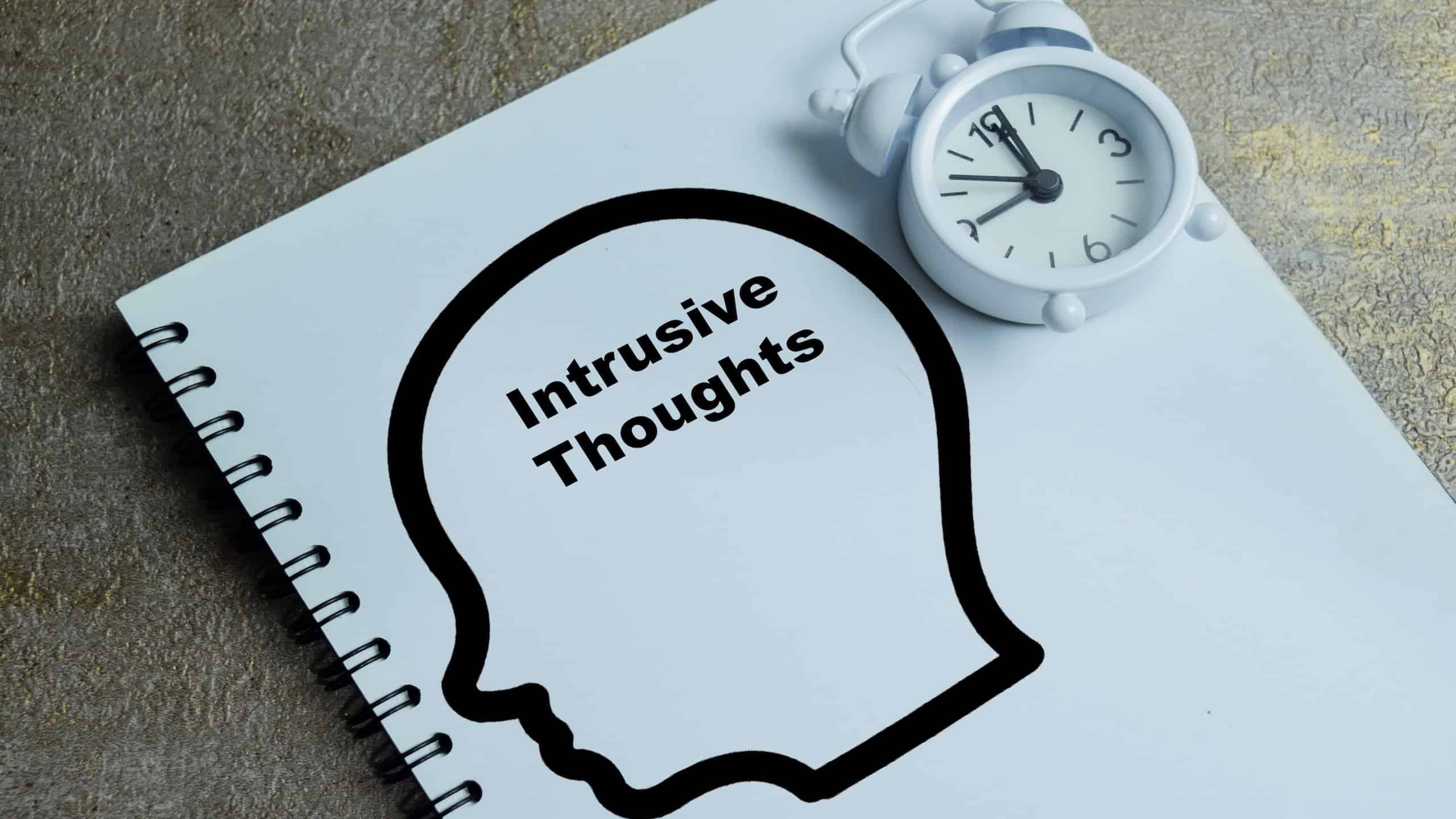 Concept of intrusive thoughts write on book isolated on Wooden Table. For anxiety disorder and obsessive