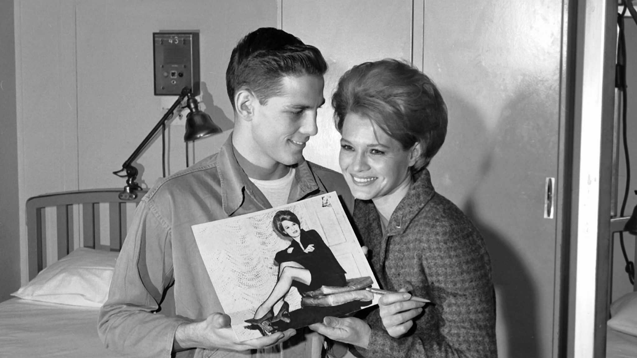 Actress Angie Dickinson signs an autograph for a patient at Fitzsimons Army Hospital in 1964