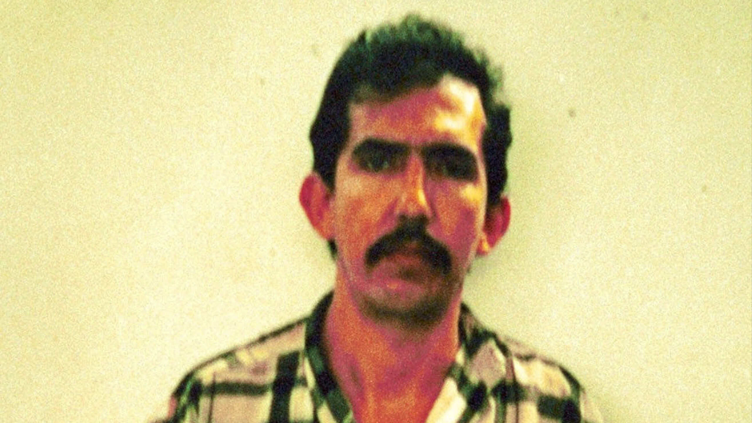 Full, uncropped mugshot of serial killer Luis Garavito, taken by the Colombian National Police after his arrest in 1999.