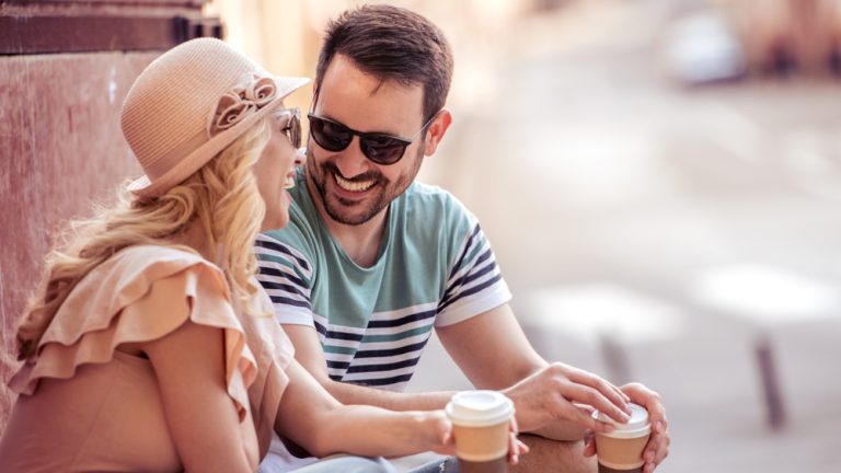 Happy young couple having fun and laughing together outdoors.Holidays,people,vacation, love and travel concept.