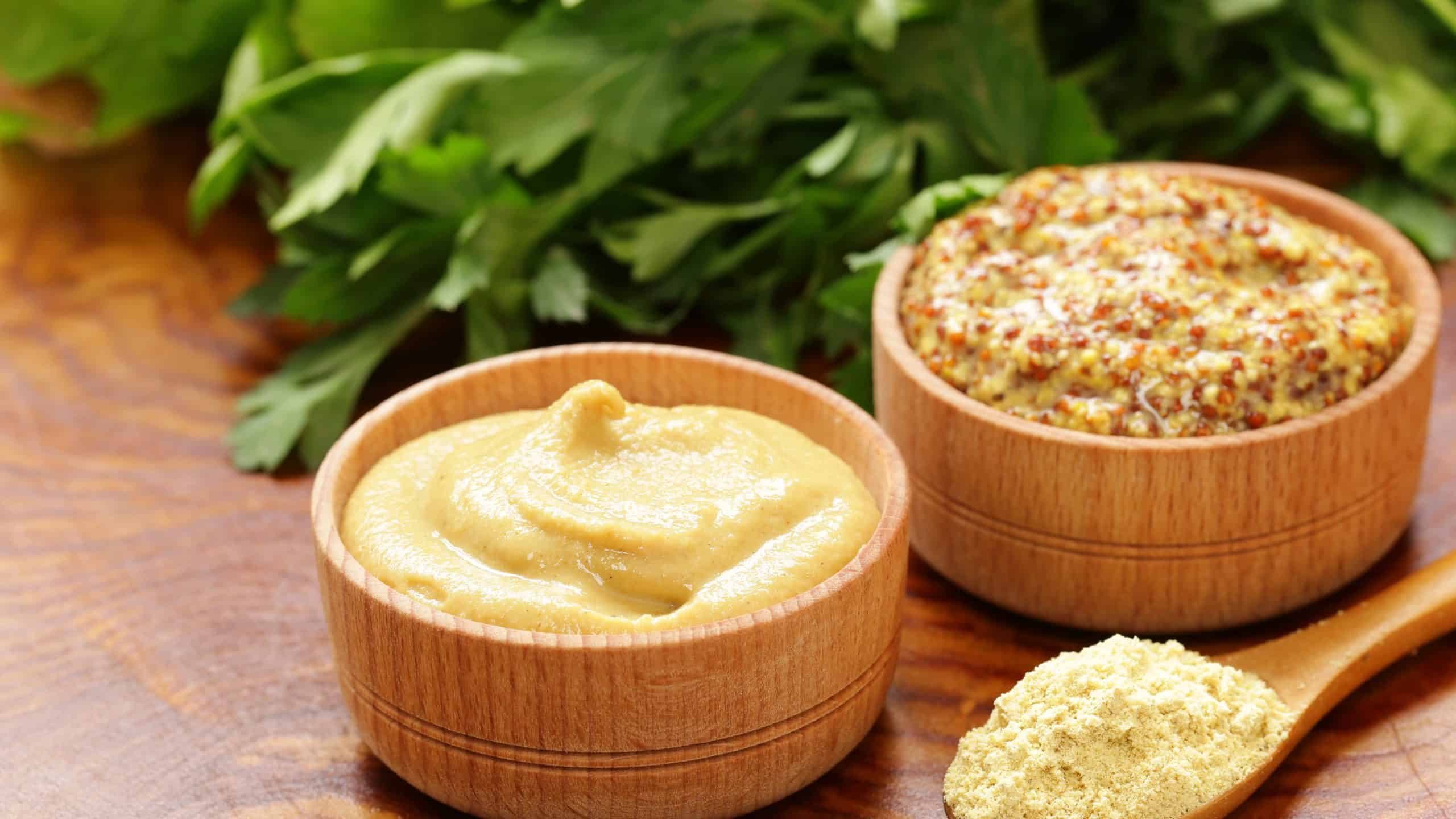 Natural mustard, seasoning and sauce on a wooden table