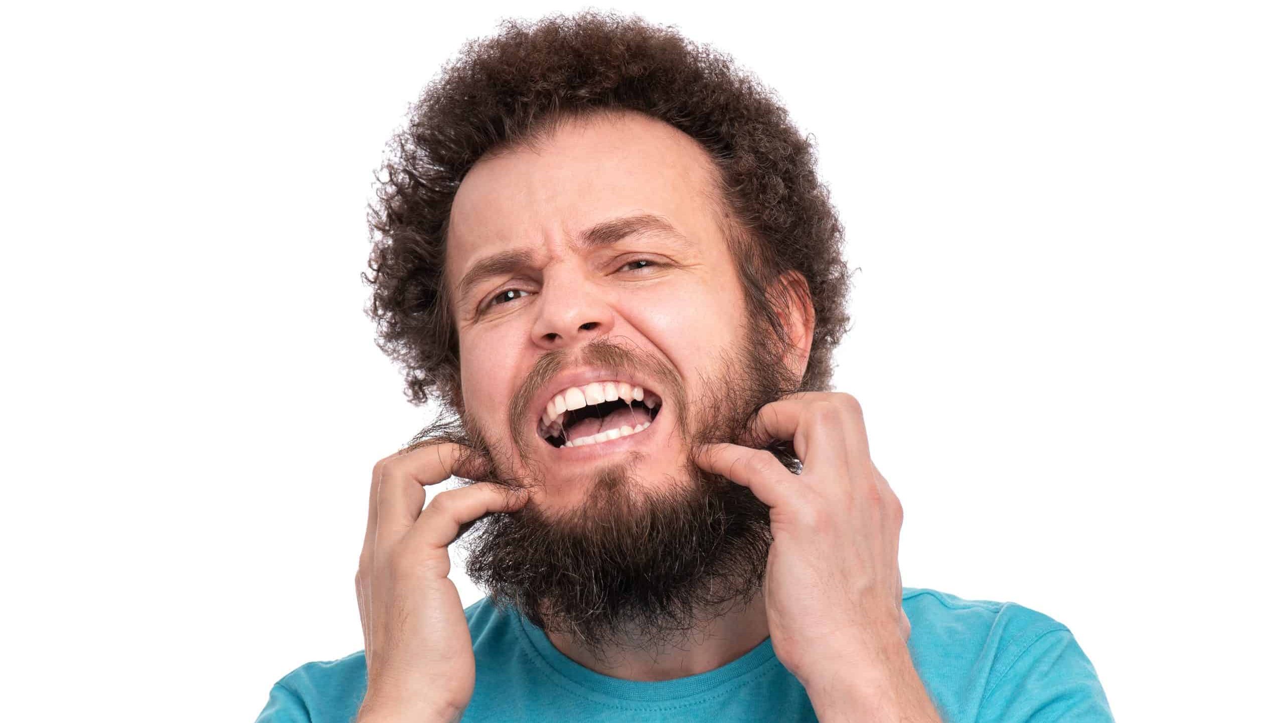 Crazy bearded Man with funny Curly Hair scratching messy beard, isolated on white background. Emotions and signs concept.