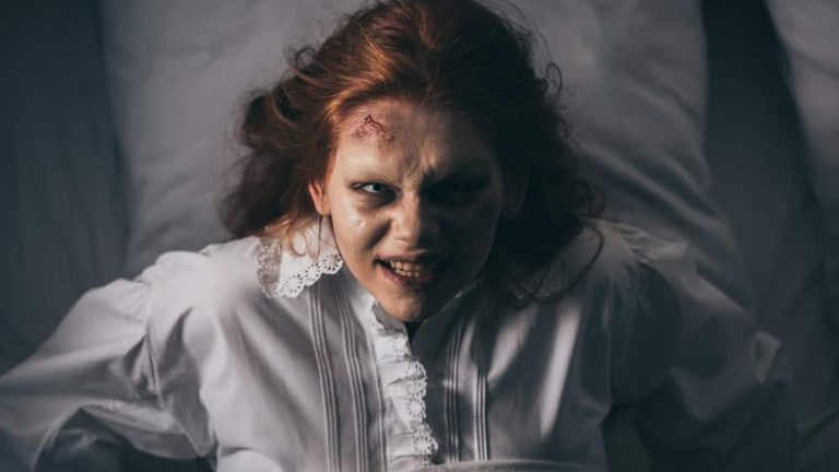 top view of paranormal girl in nightgown lying in bed