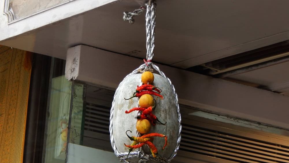 Lemon,chilli and green pumpkin hung in the door way or entrance of an Indian shop to stop evil eye effects as per Hinduism
