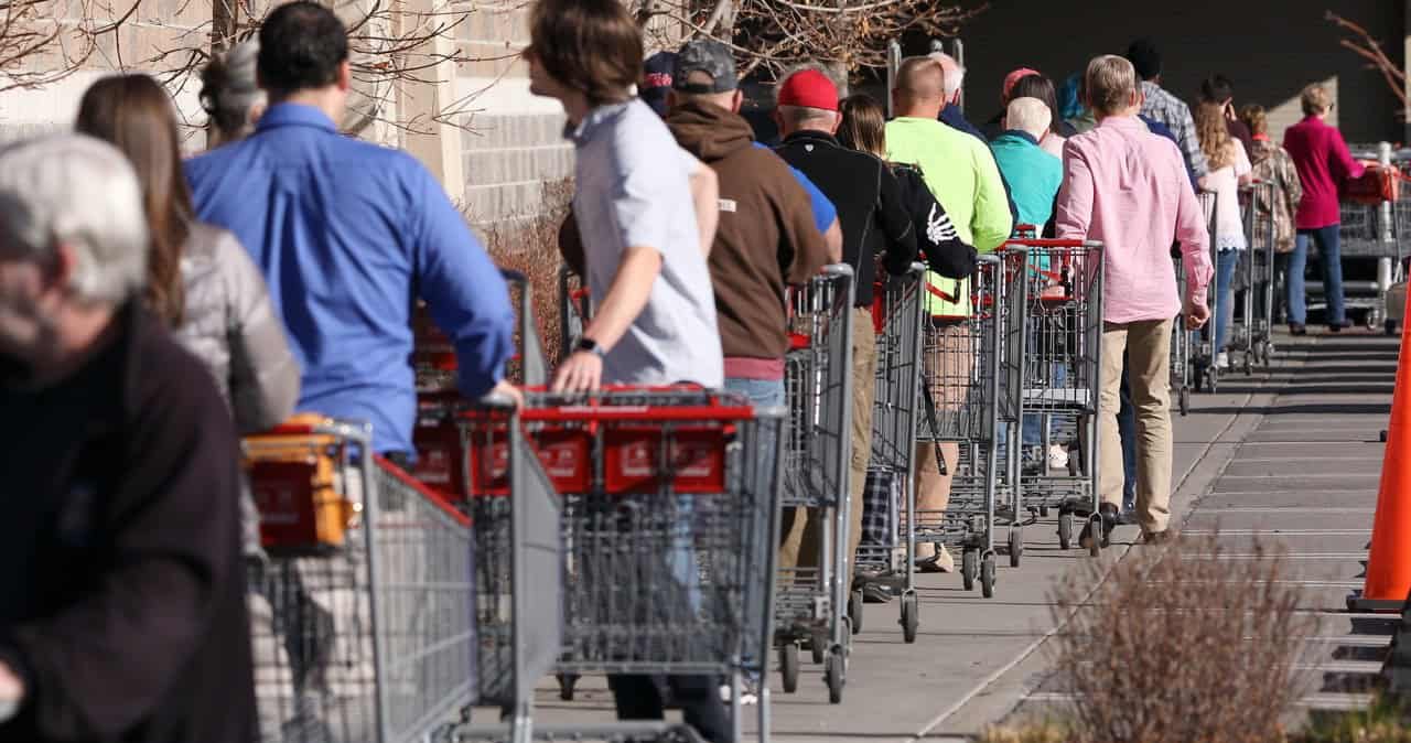 Circa - Orem, Utah / United States - 03/17/2020 - People with shopping carts waiting in line during the Covid-19 pandemic.