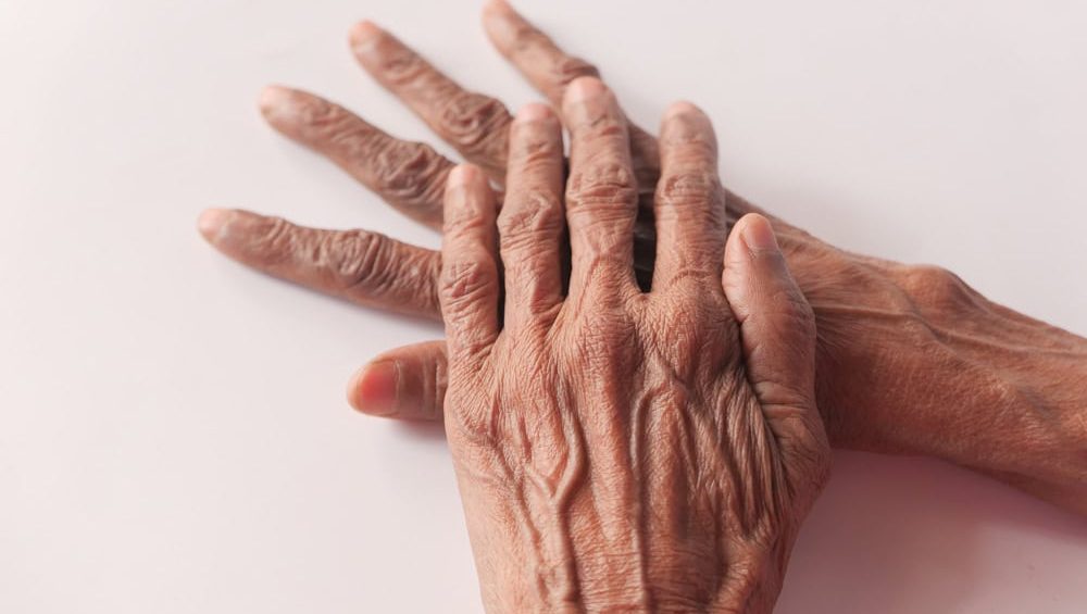 close up of hand of a elderly person isolated on white