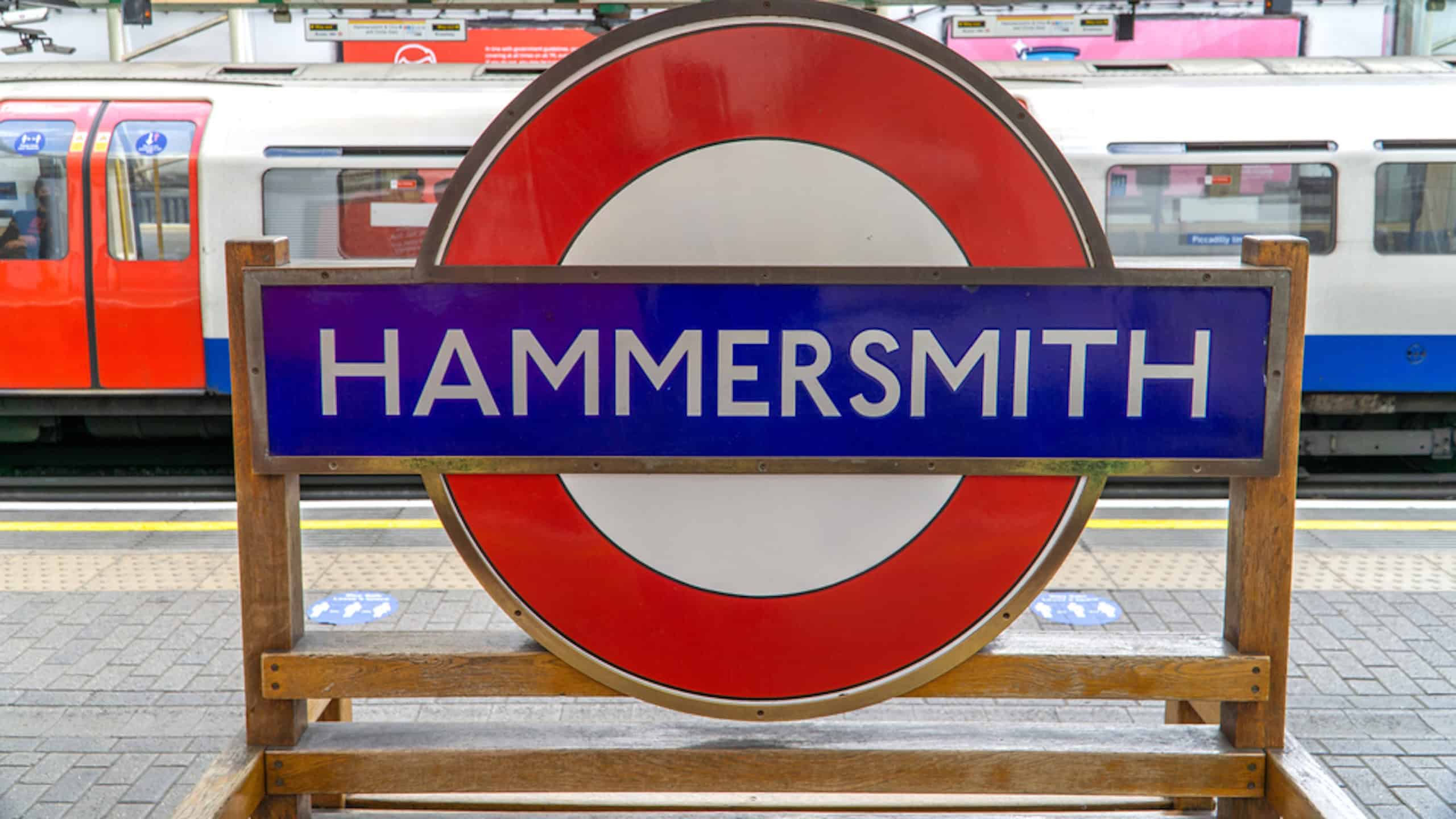 London, UK - 4 May 2021: Hammersmith tube station sign on a platform bench