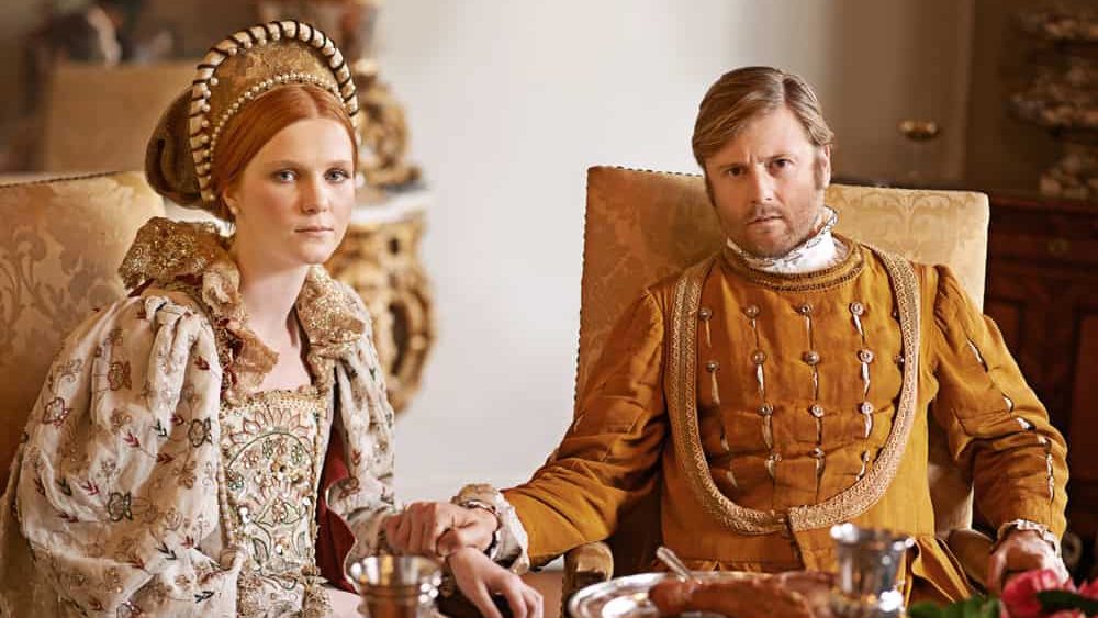 Its an ample feast. Shot of a noble couple eating together.
