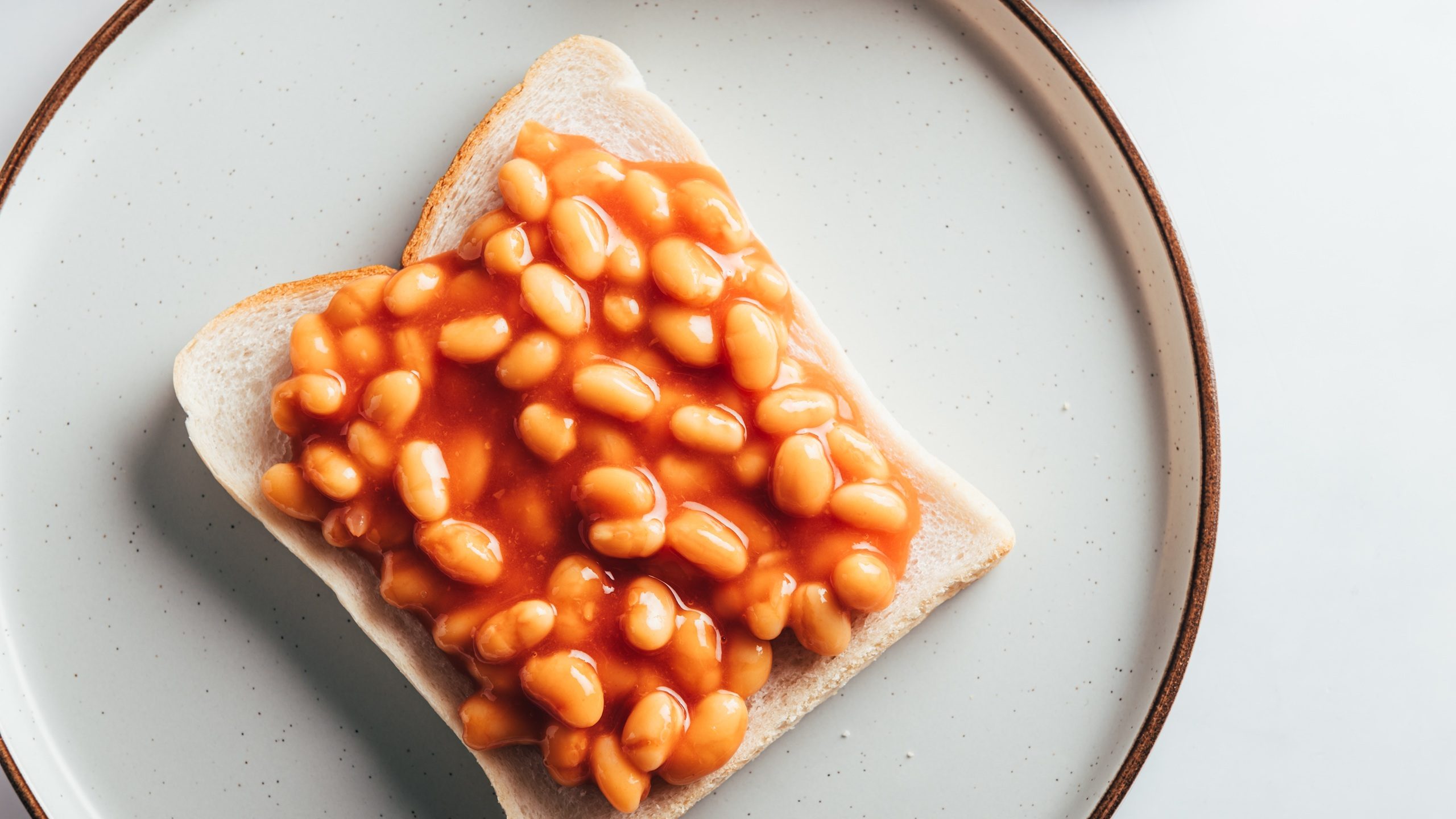 Baked Beans in Tomato Sauce on Slice of Toasted Bread, traditional British breakfast