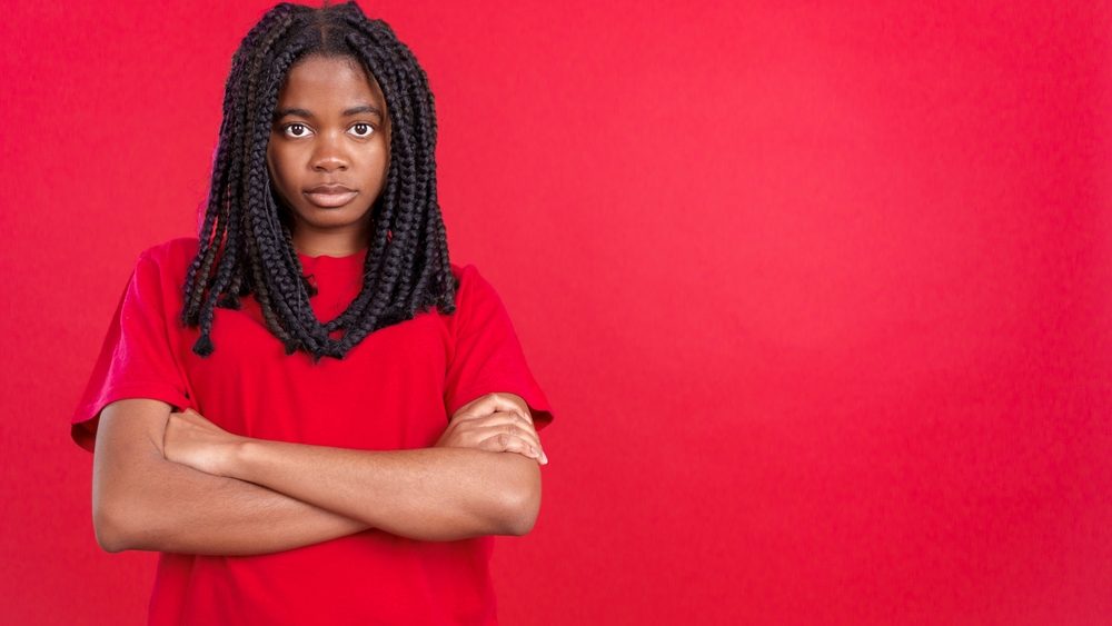 African woman crossing the arms with an angry expression