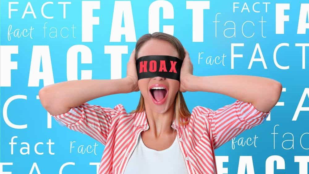Ignoring,Facts.,Woman,Wearing,Blindfold,With,Word,Hoax,On,Blue