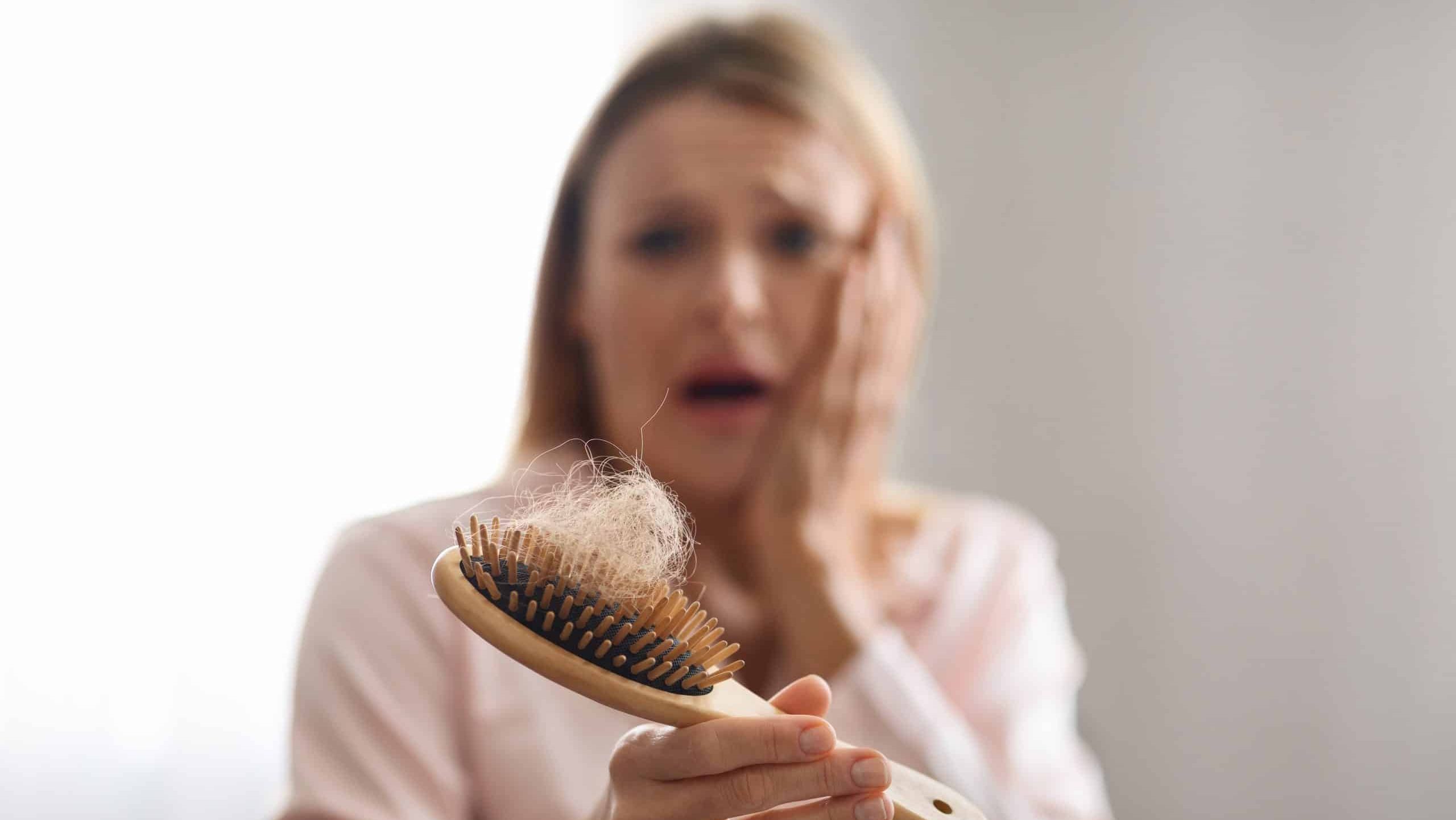 Worried Mature Woman Suffering From Hairloss, Stressed Middle Aged Woman Holding Comb Full Of Fallen Hair And Touching Face With Shock, Scared Lady Having Alopecia Symptoms, Selective Focus