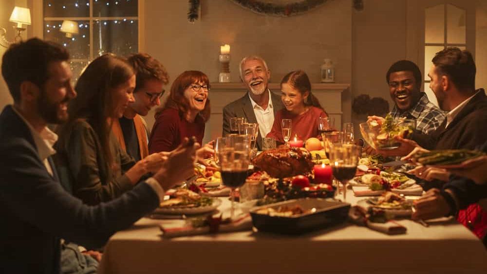 Multi-Generational Family Members Share Funny Stories and Joy During a Christmas Turkey Dinner. Happy Parents and Kids Singing Christmas Carols Together, Dancing Behind a Table and Lighting Sparkles