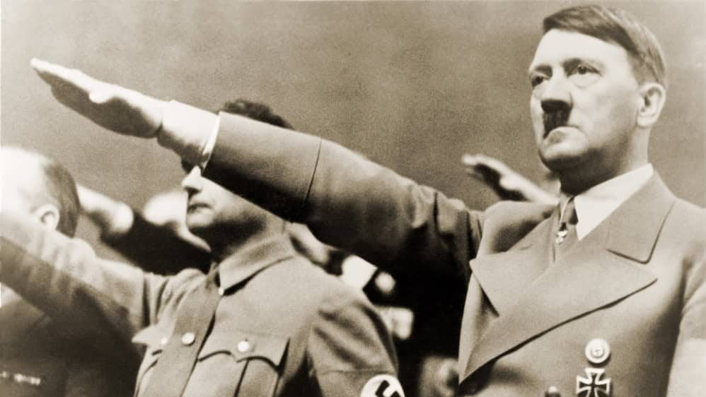 Adolf Hitler, giving Nazi salute. To Hitler's right is Rudolph Hess. 1939.