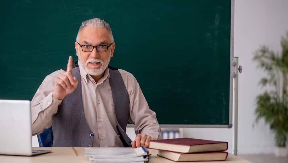 Old male teacher in the classroom