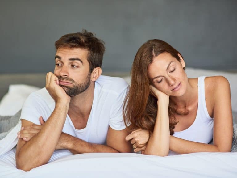 Bedroom, bored and ignore with couple, divorce and home with argument, emotion and separate. People, tension or man with woman, dispute and crisis with marriage, conflict or stress with relationship