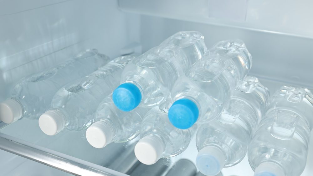 Many bottles of water in refrigerator, closeup