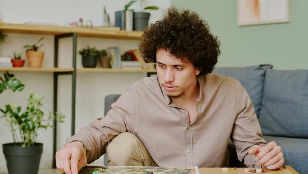 Medium,Shot,Of,Young,Gen,Y,Biracial,Man,Sitting,At