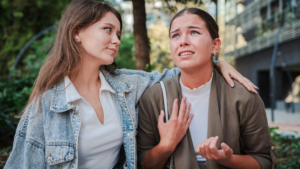 Upset woman sharing her problems with a comforting friend in an emotional , depicting support, empathy, and friendship during a difficult moment. Mental health and relationships. Females trouble. High