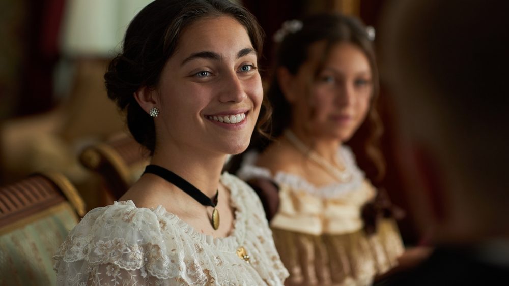 Portrait,Of,Young,Woman,In,Lace,Gown,Smiling,At,Companion